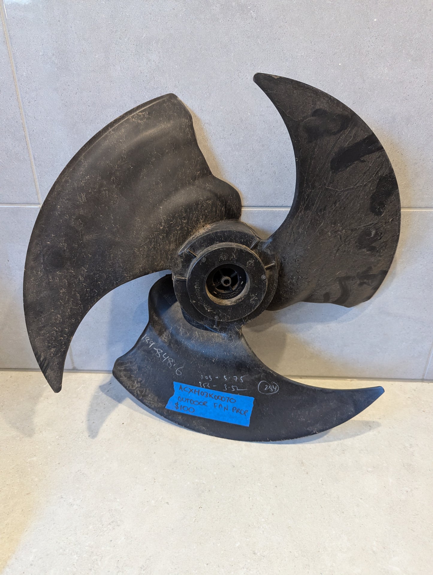 Black aerodynamic outdoor fan propeller blade on tiled background