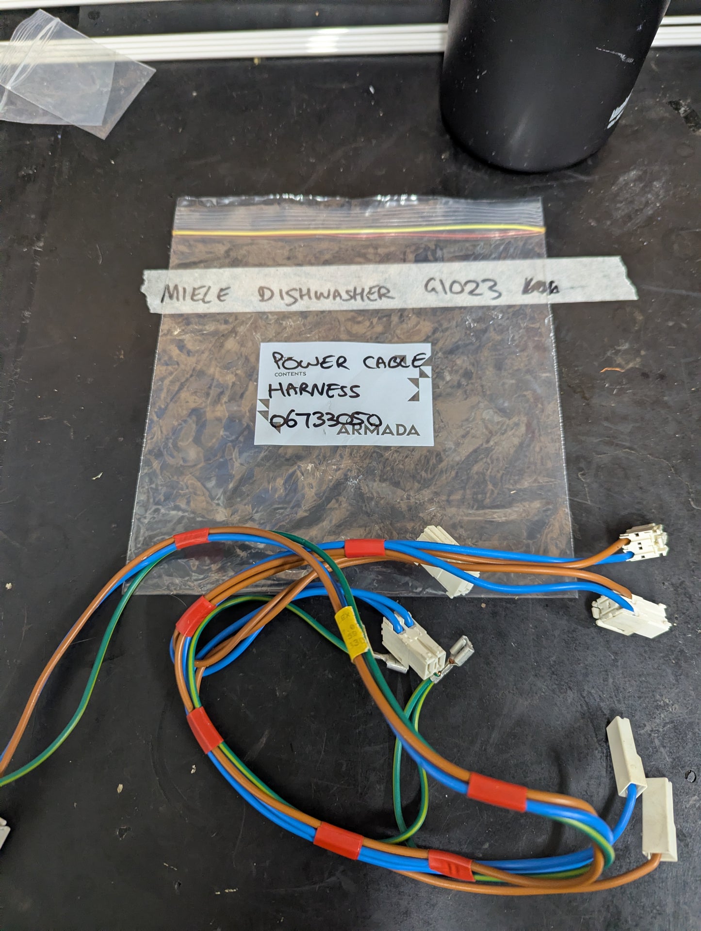 Miele G1023 dishwasher power cable harness with color-coded wires and connectors on a labeled bag