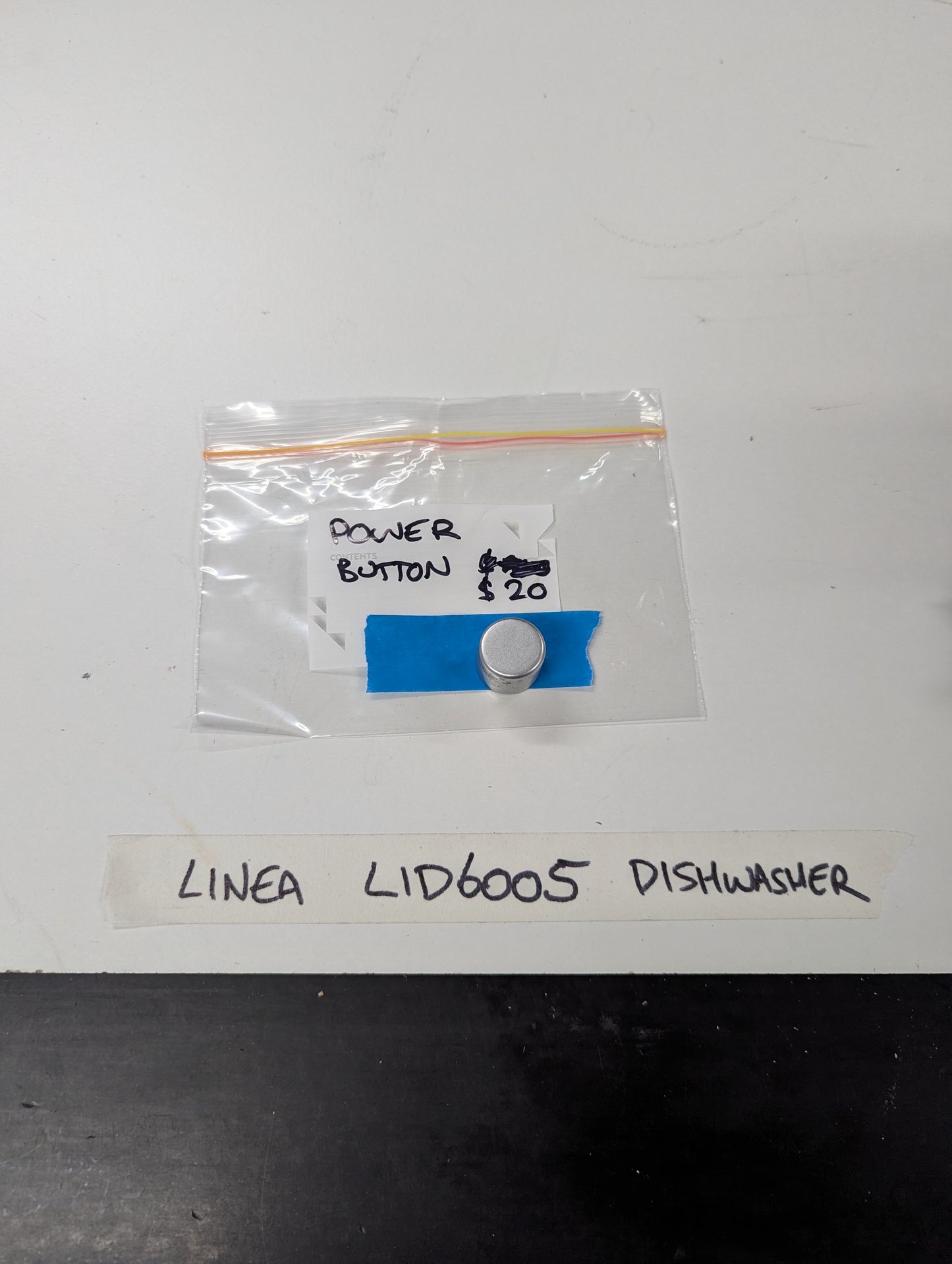Linea LID6005 dishwasher power button in plastic bag with handwritten label