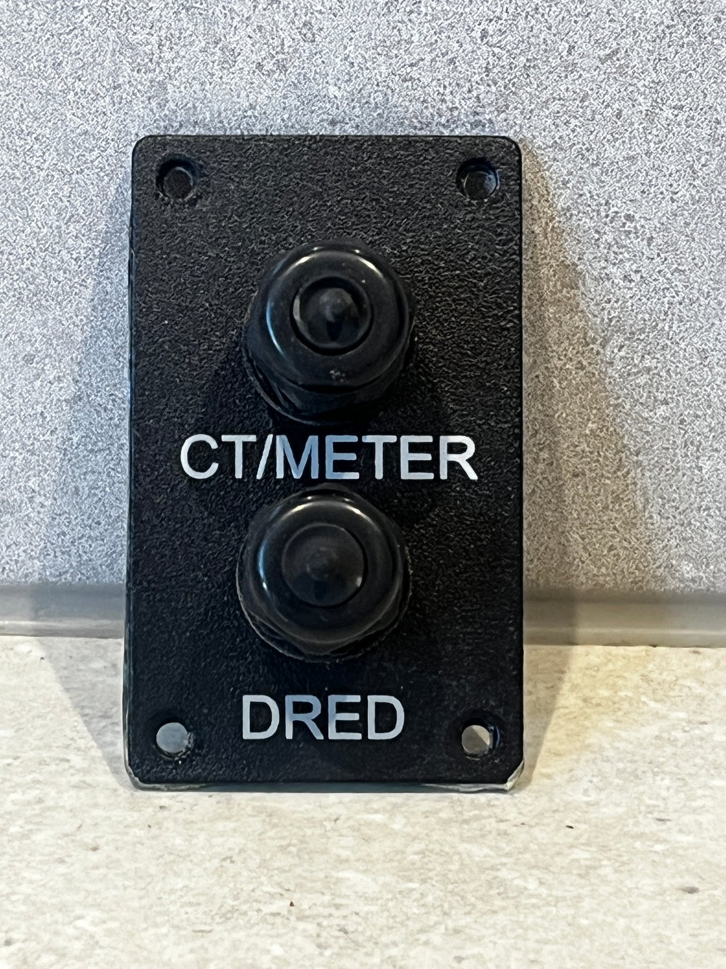Dual push button switch plate labeled CT/Meter and DRED