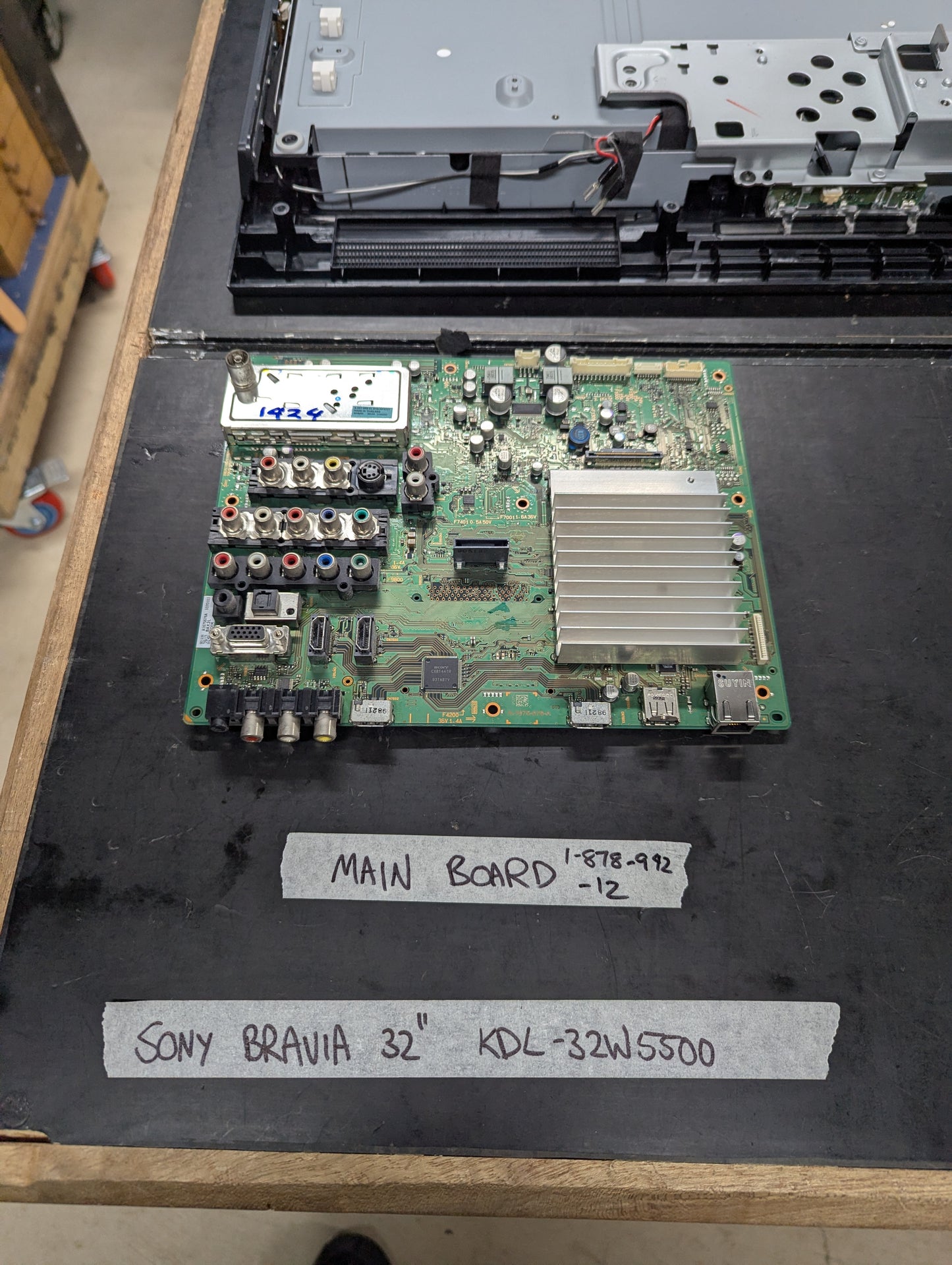 Sony Bravia 32 inch KDL-32W5500 main board with multiple AV and HDMI ports on a tech bench