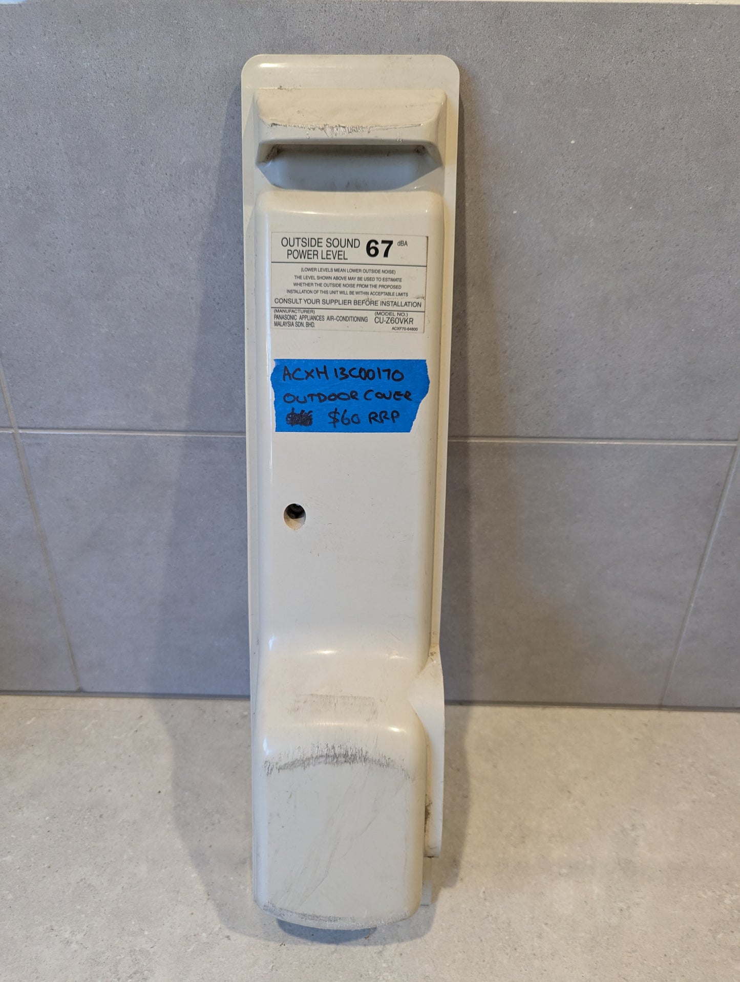Air conditioner outdoor unit cover in off-white plastic, labeled model ACXH13C00170