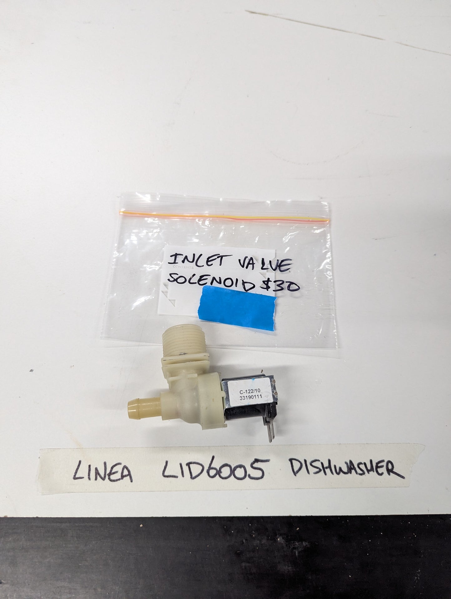 Linea LID6005 dishwasher inlet valve solenoid on white background with labeled bag