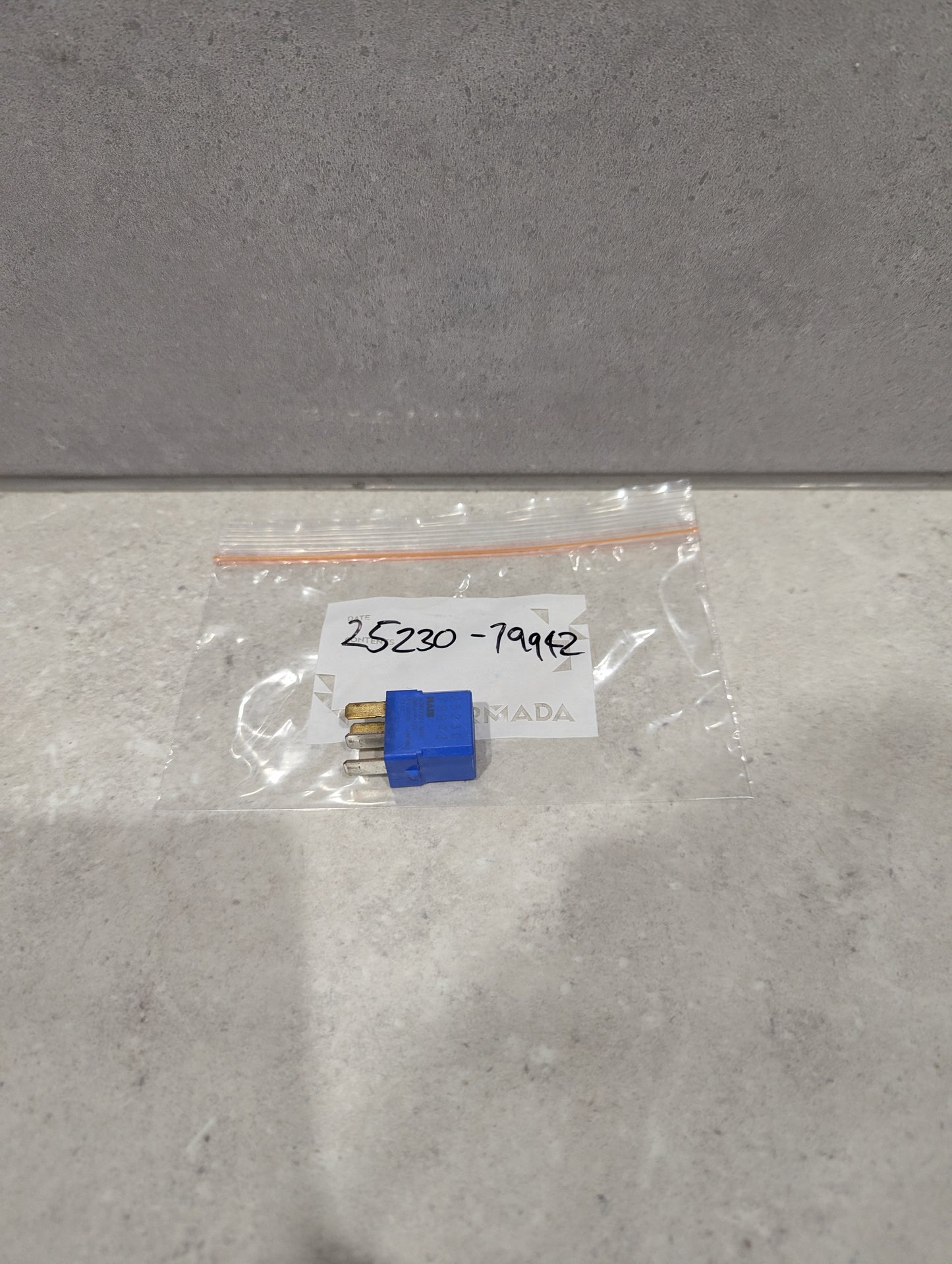 Blue automotive relay plug connector in clear plastic bag labeled 25230-79942