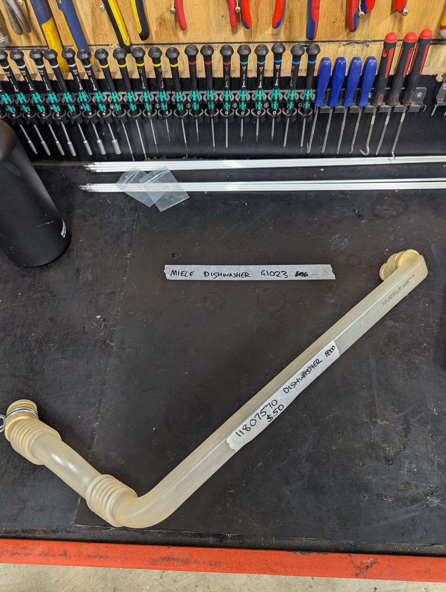 Replacement Miele dishwasher feed hose for G1023 model on workbench