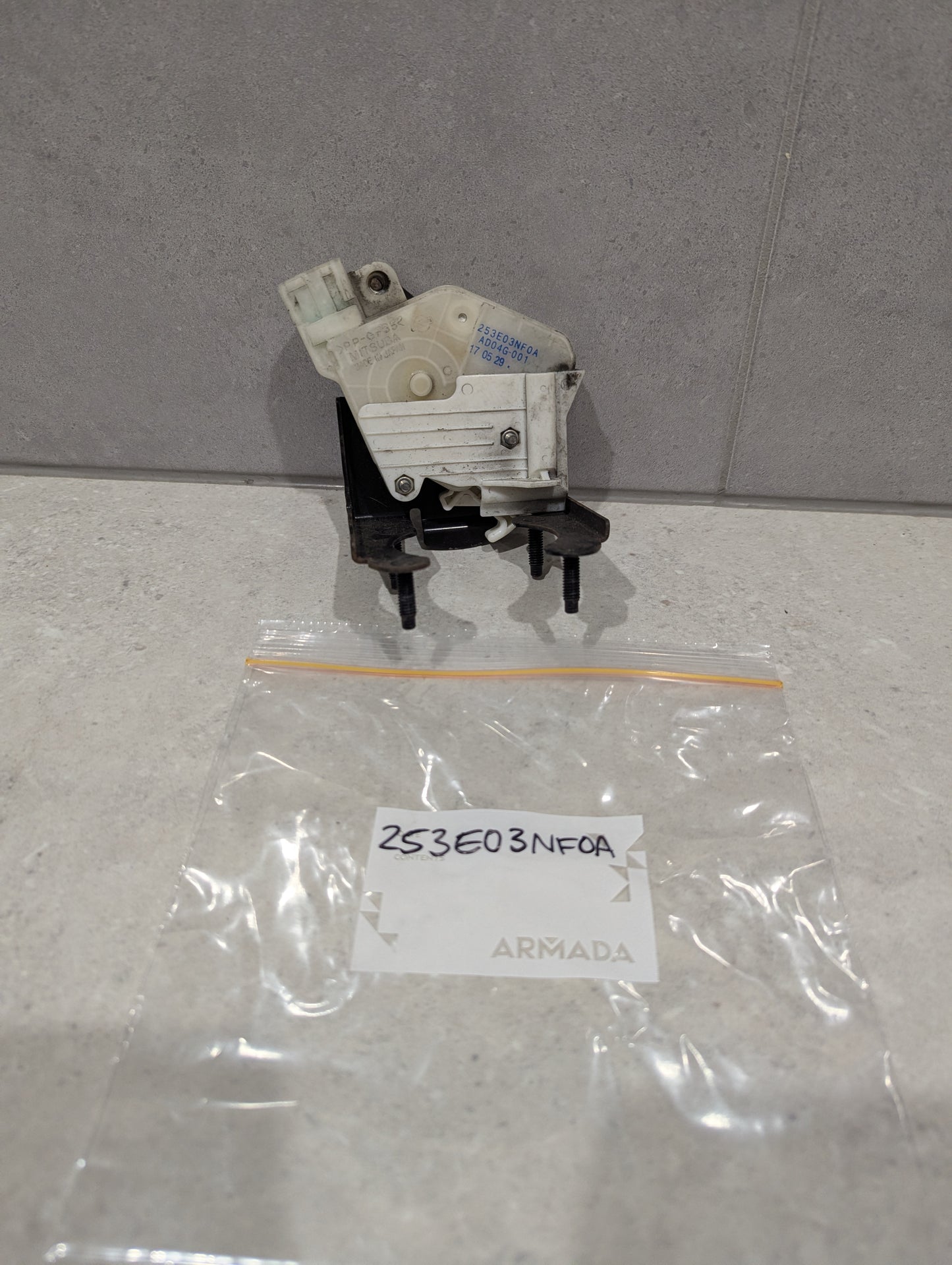 Nissan door lock actuator assembly and labeled resealable bag