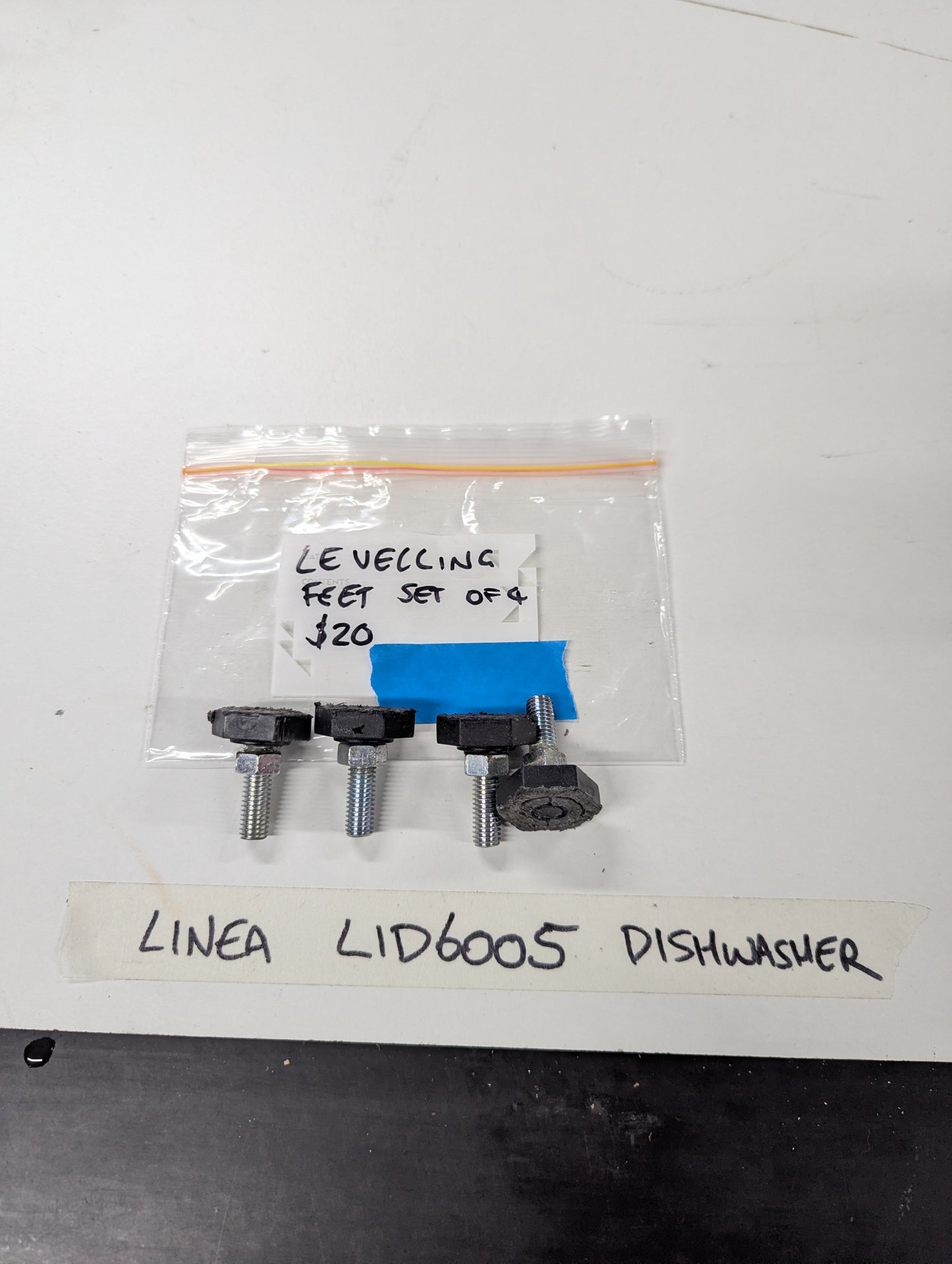 Set of four Linea LID6005 dishwasher leveling feet with bag and label