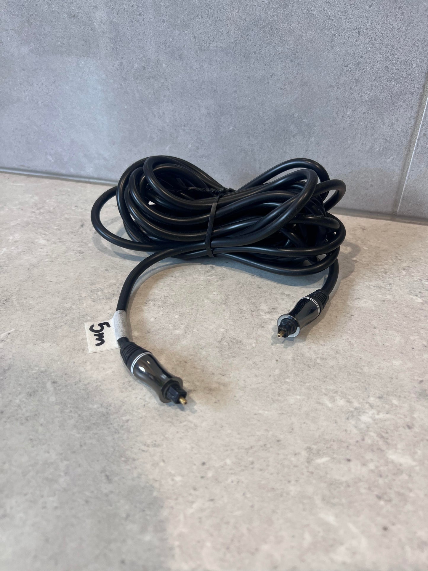 Digital optical audio cable with Toslink connectors on a counter