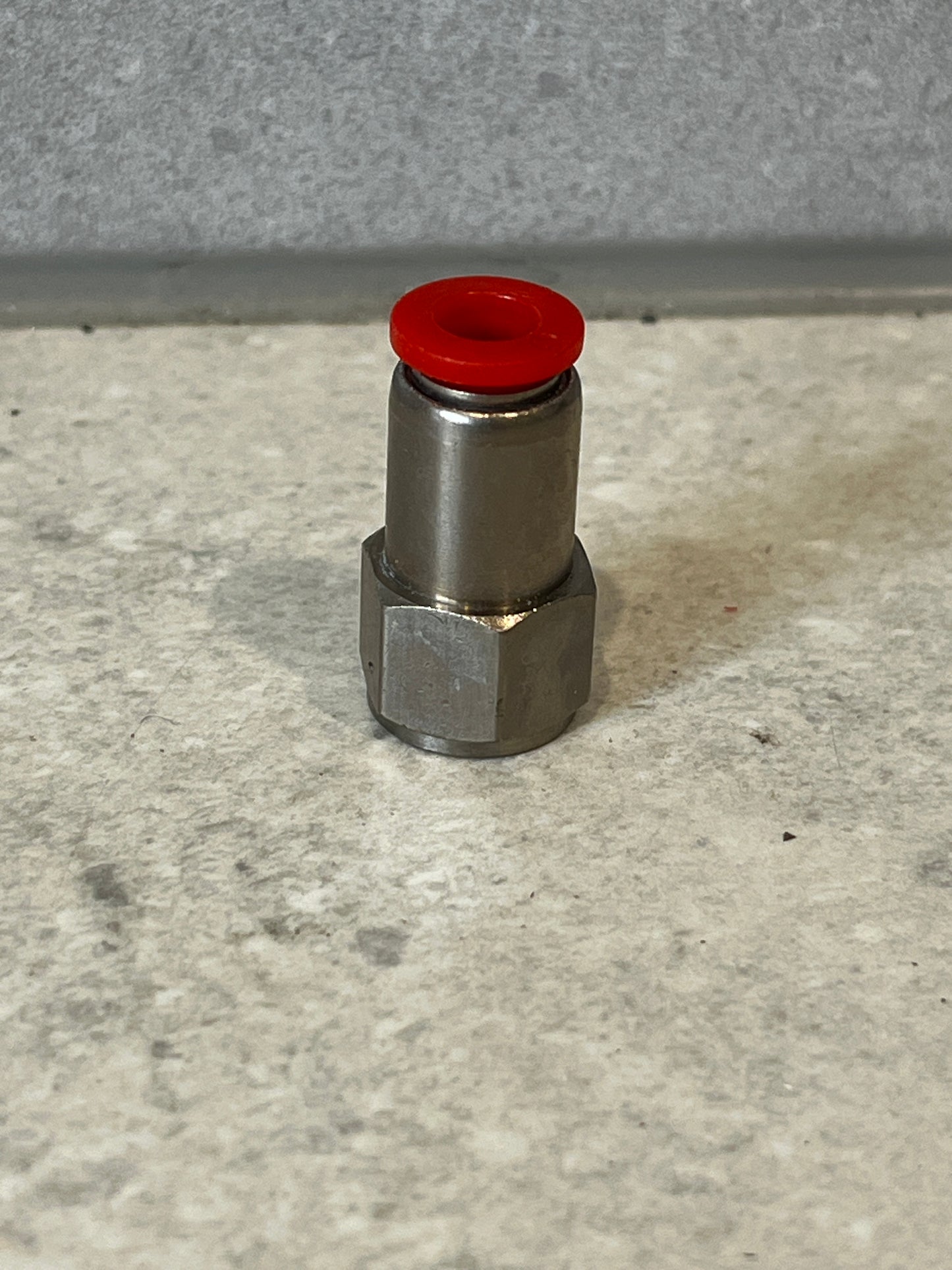 Stainless steel push-to-connect fitting with red seal ring