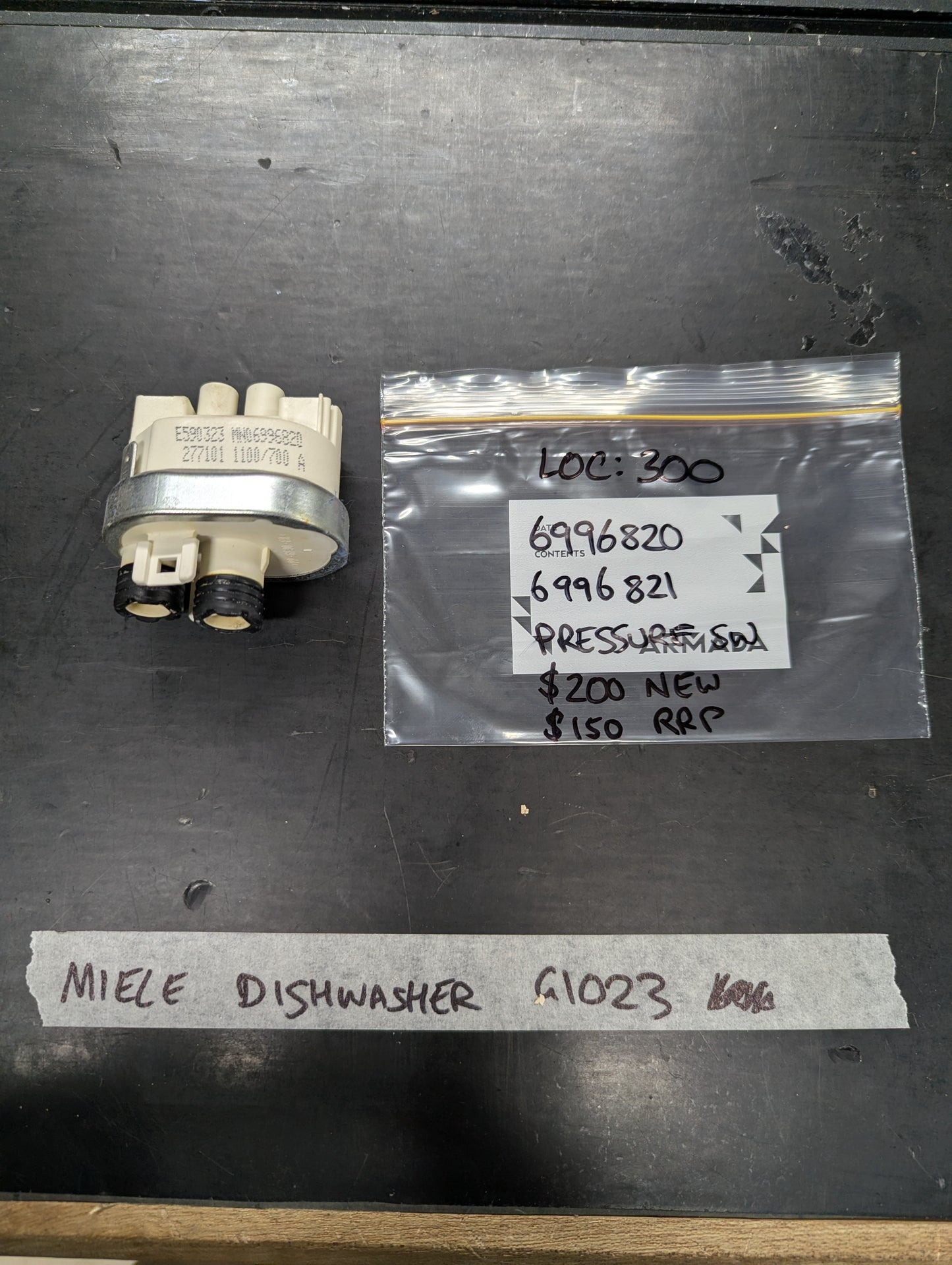 Miele dishwasher pressure switch model G1023 with labeled bag and part numbers