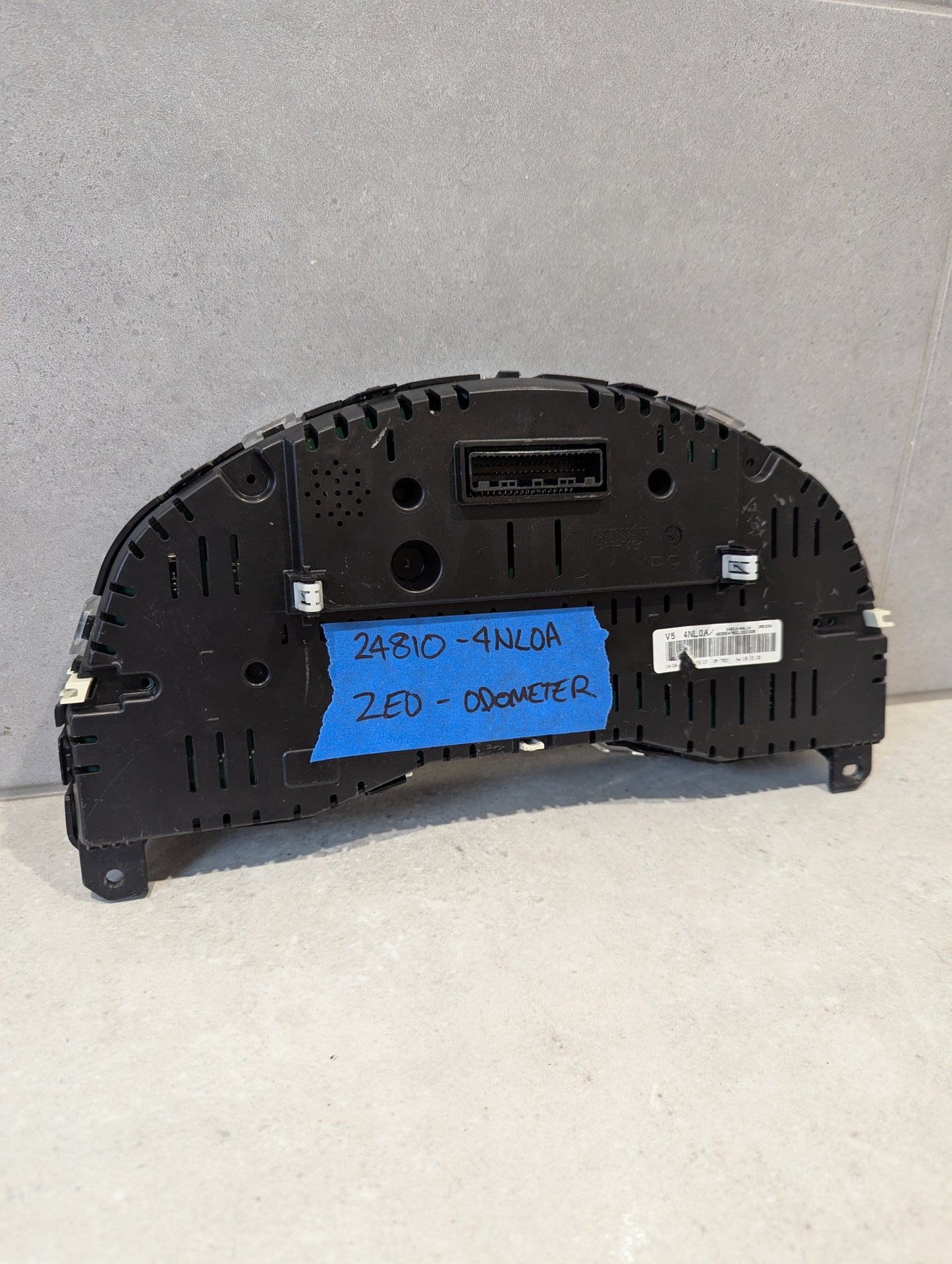 Rear view of Nissan Leaf ZE0 odometer cluster showing connectors and part number