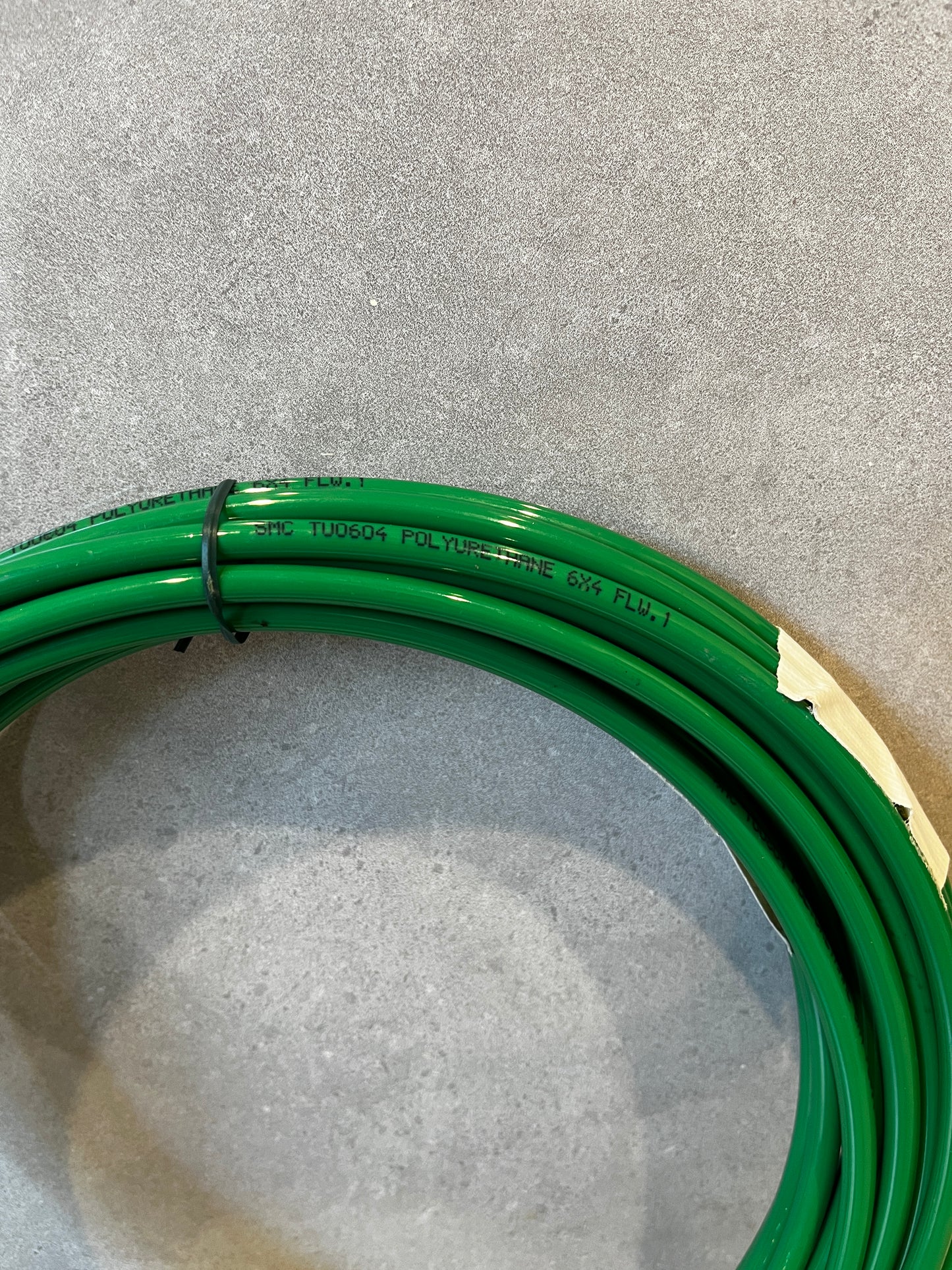 Close-up of green polyurethane tubing coil showing material and label