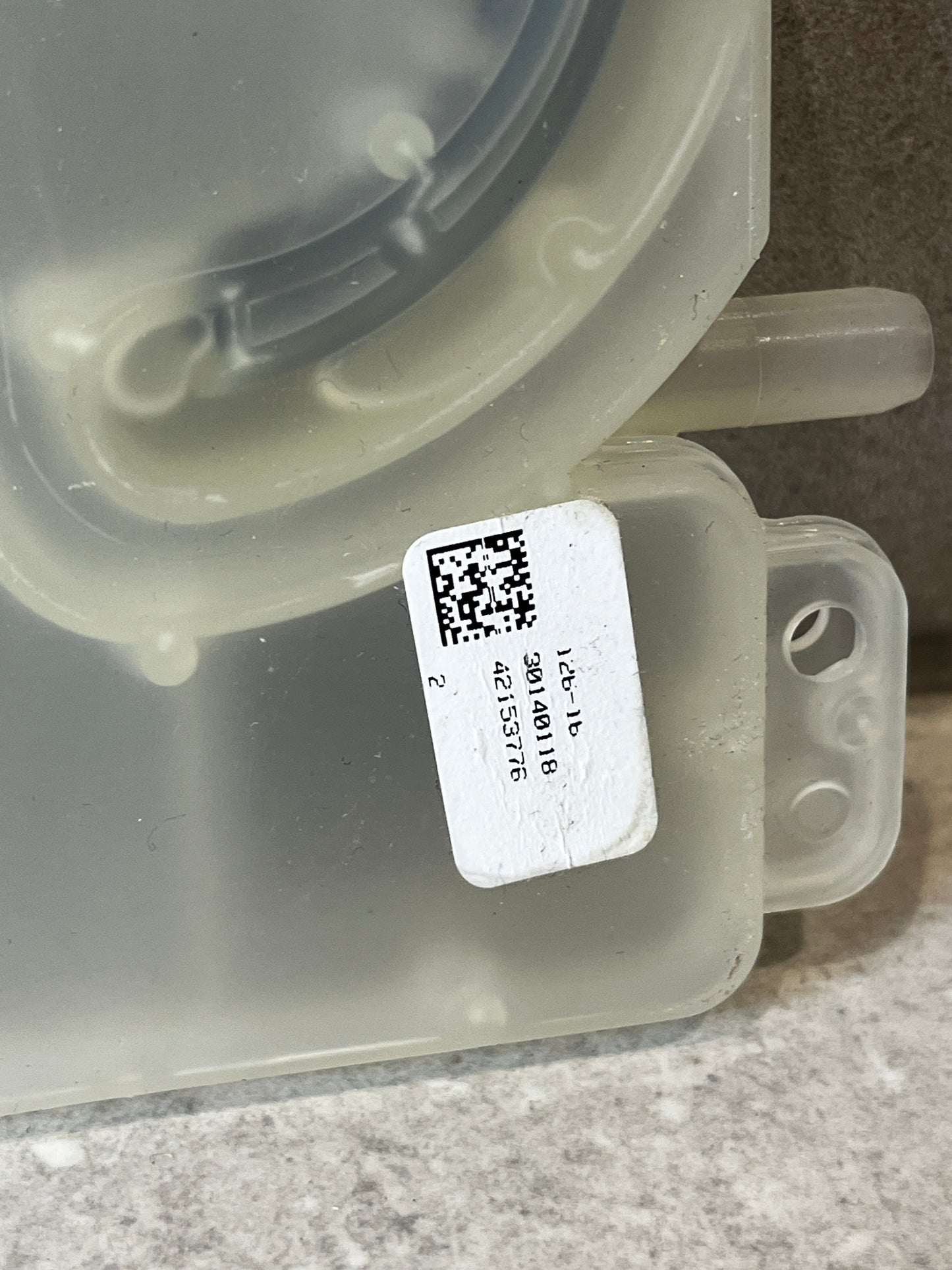 Close-up of dishwasher inlet valve with label and part number