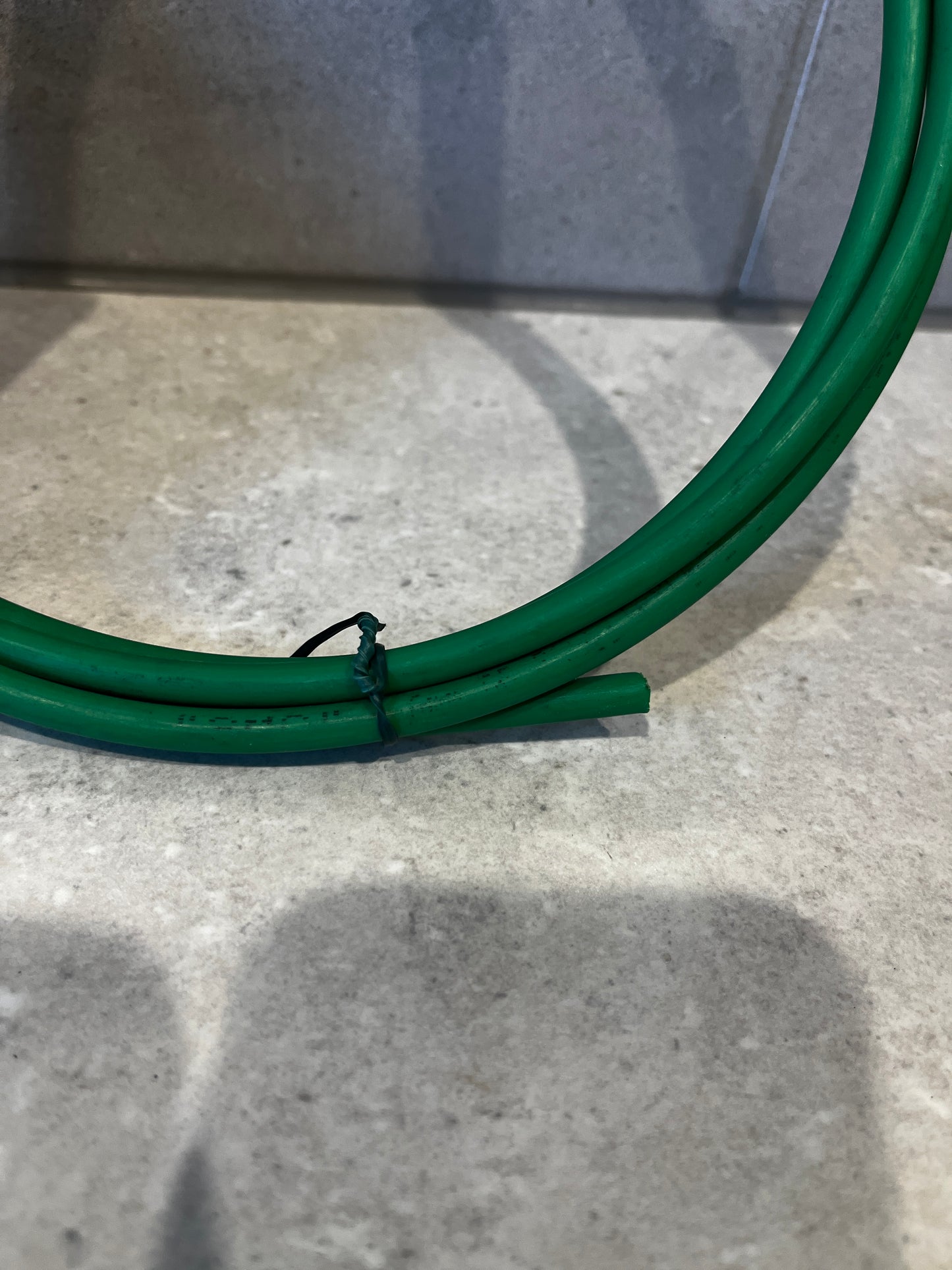 Close-up of green plastic tubing hose ends showing flexibility and durable material