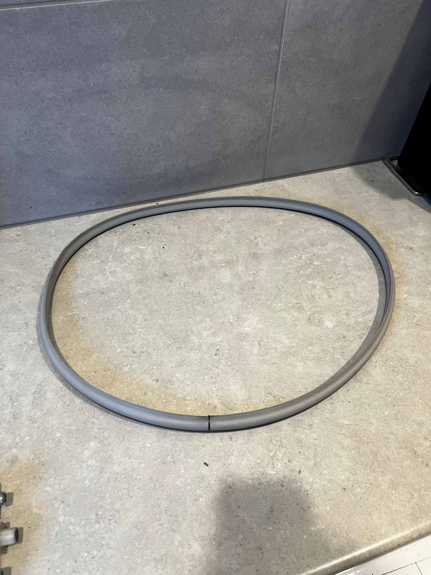 Flexible gray washing machine door seal gasket on countertop