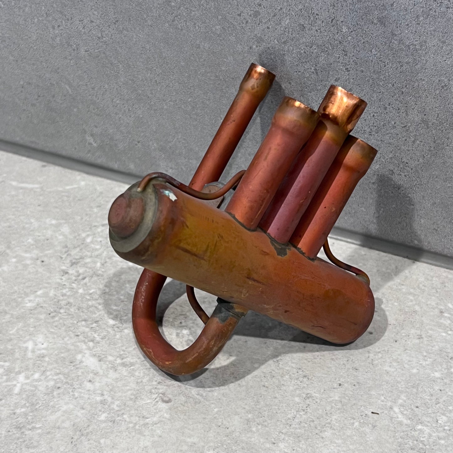 Angled view of Saginomiya STF40202G copper reversing valve on gray background