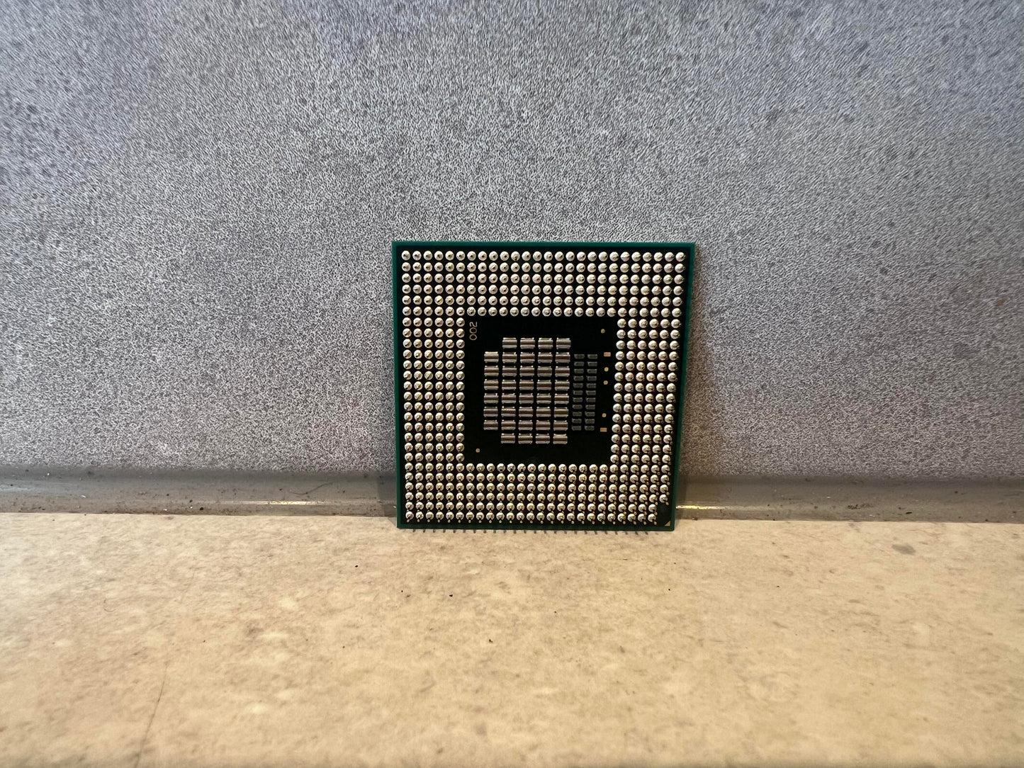 Back view showing pins of Intel SL8YP laptop processor chip