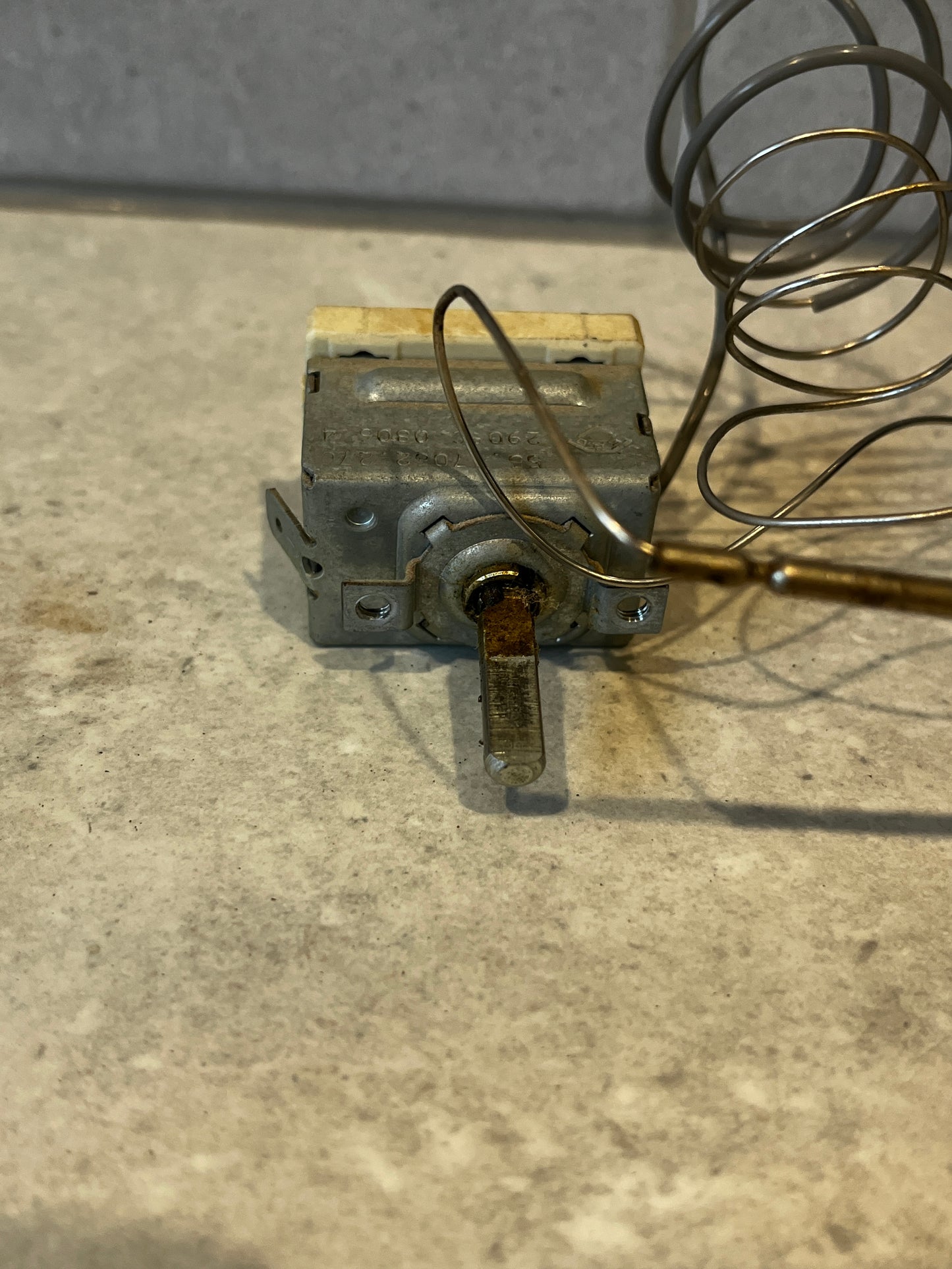 Temperature control thermostat switch showing the metal lever and flexible sensing wire coil