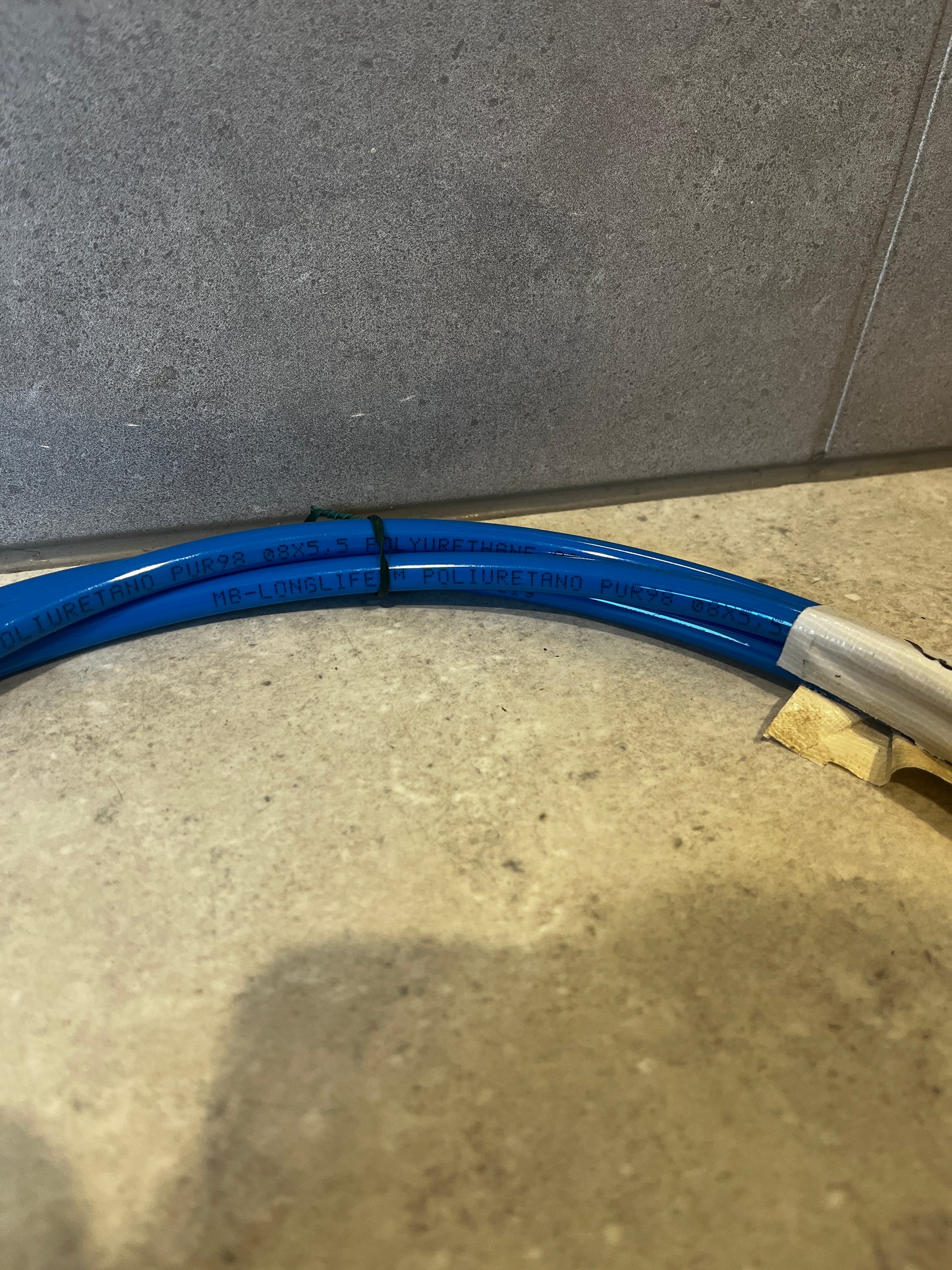 Close-up of blue polyurethane tubing showing printed text