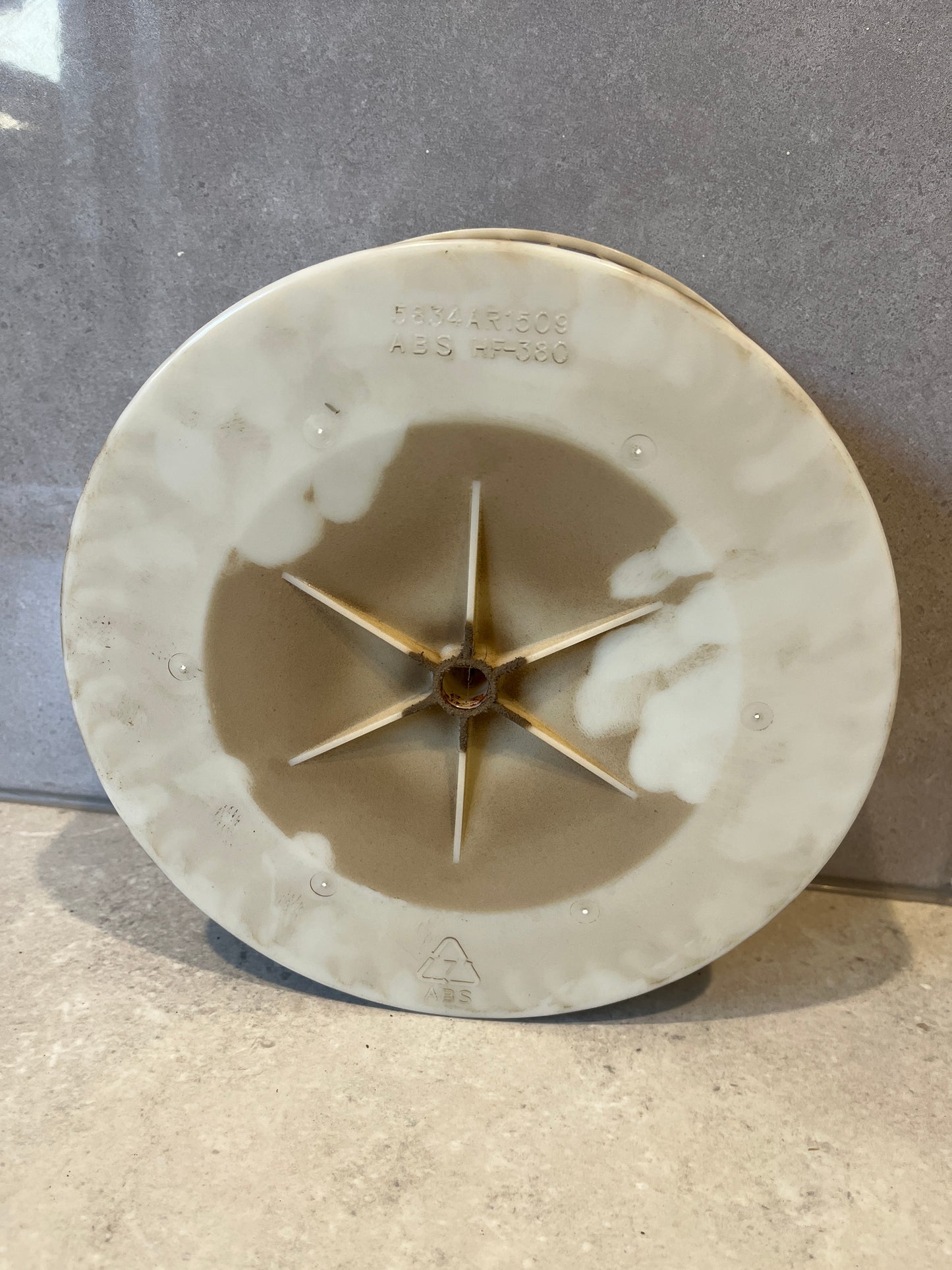 Bottom view showing ABS construction and mounting star-shaped hub of blower wheel