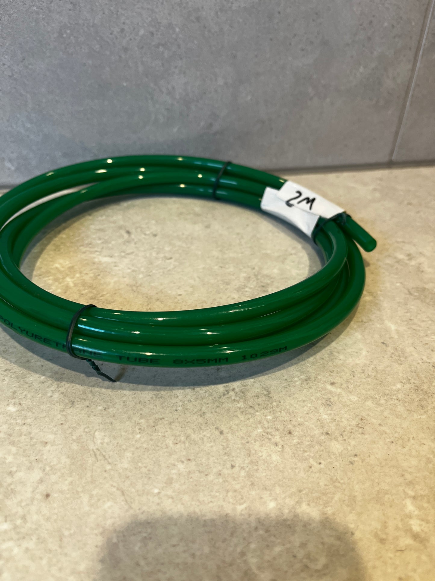 Another angle showing the green polyurethane tube coiled neatly with label