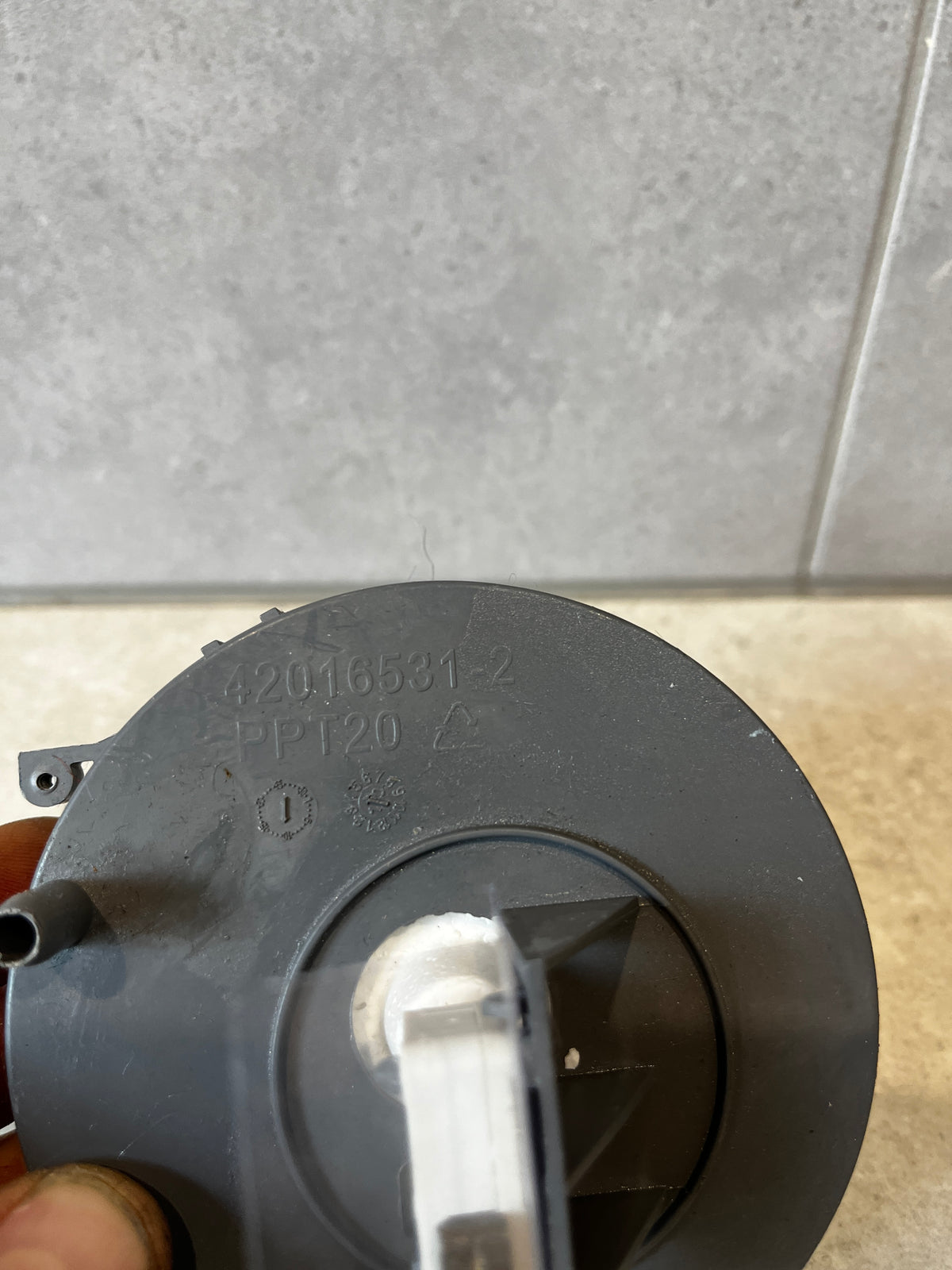 Close-up of dishwasher flow sensor showing part number and mounting details