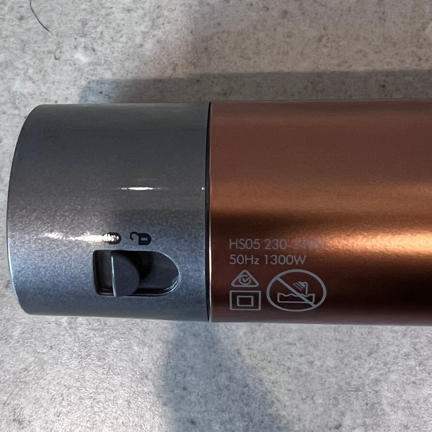Close-up of Dyson Airwrap technical specifications and lock switch
