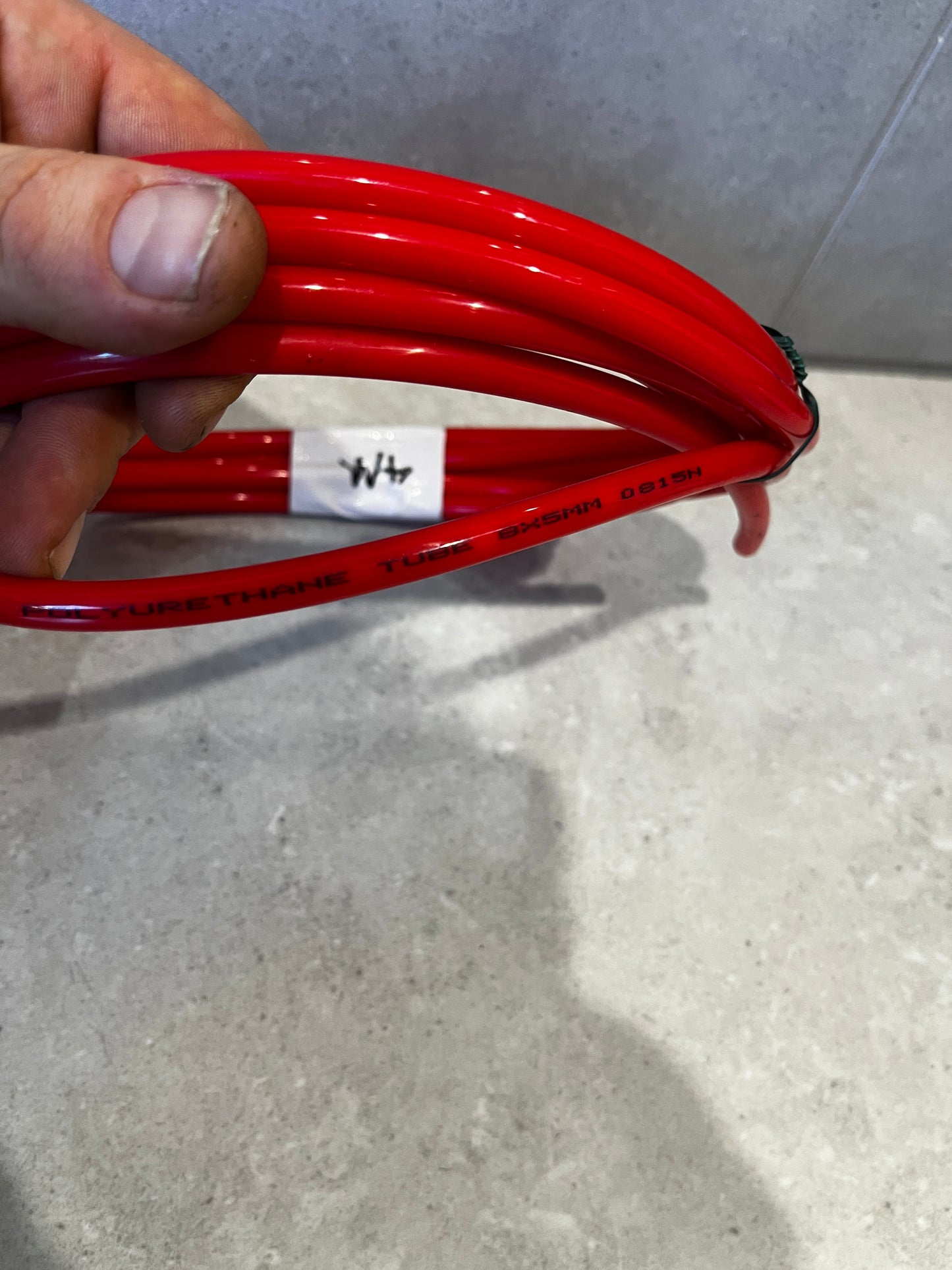 Detailed shot of red polyurethane tube marked with size 8x5mm and material info
