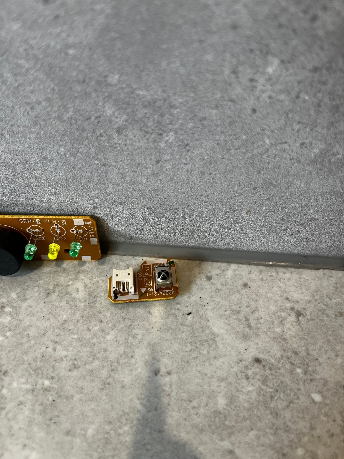 Detail view of small Daikin circuit board component with connector