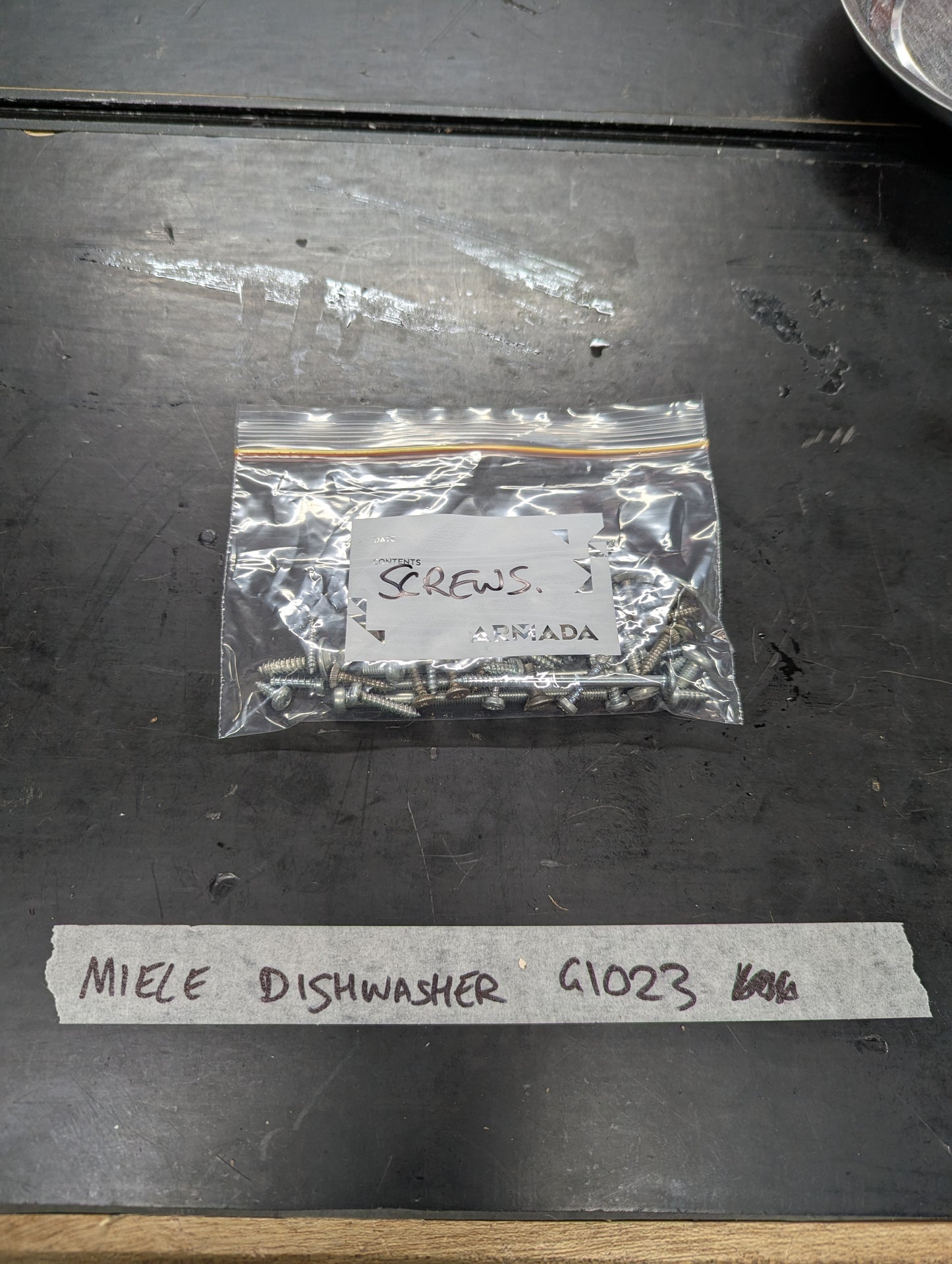 Bag of metal screws labeled for Miele Dishwasher G1023