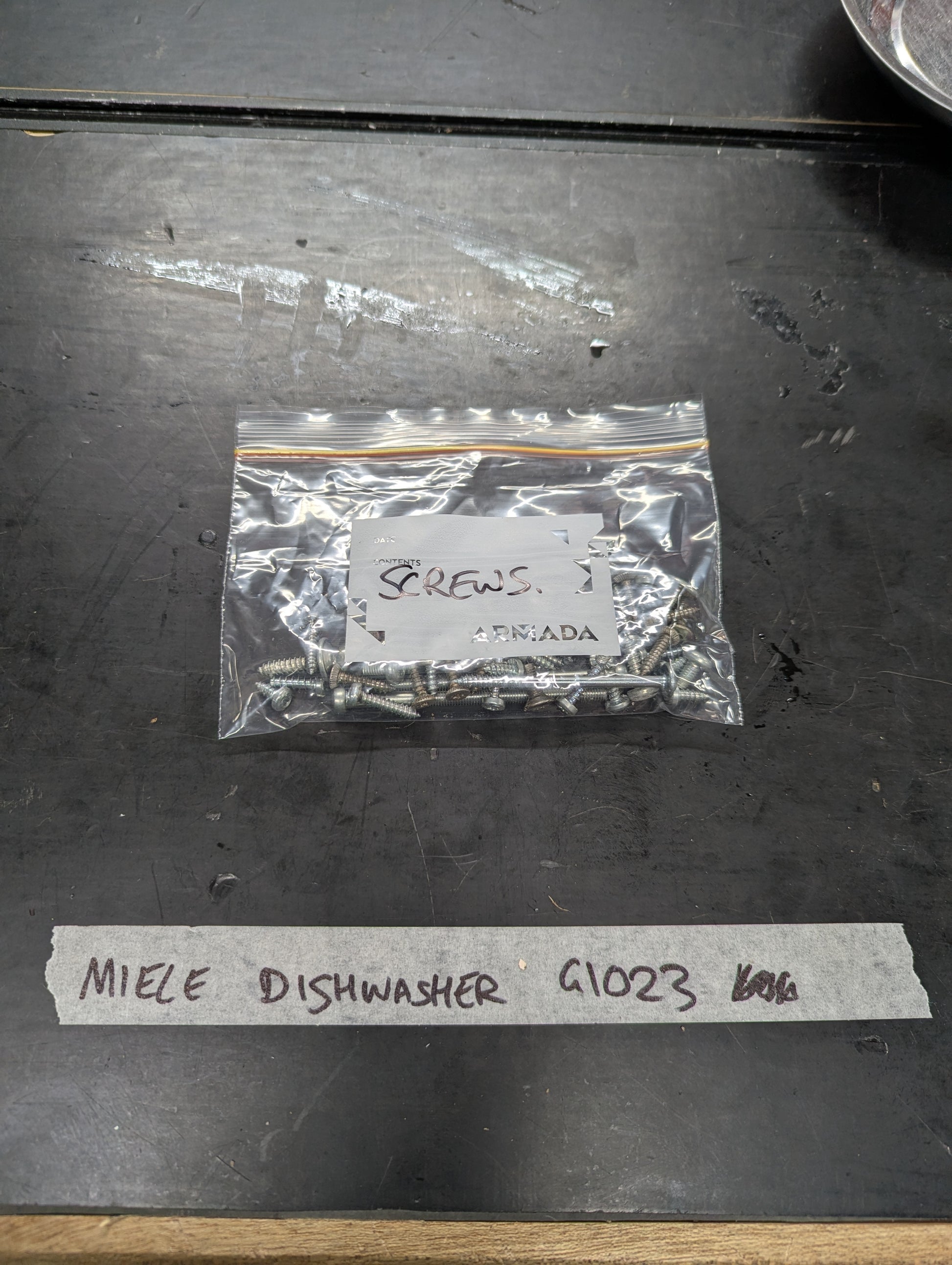 Bag of metal screws labeled for Miele Dishwasher G1023