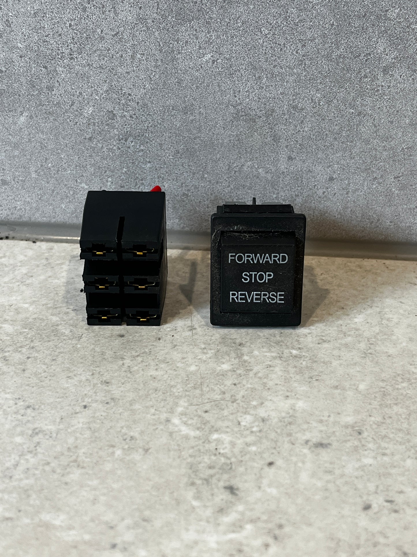 Forward reverse stop rocker switch showing front and side view.
