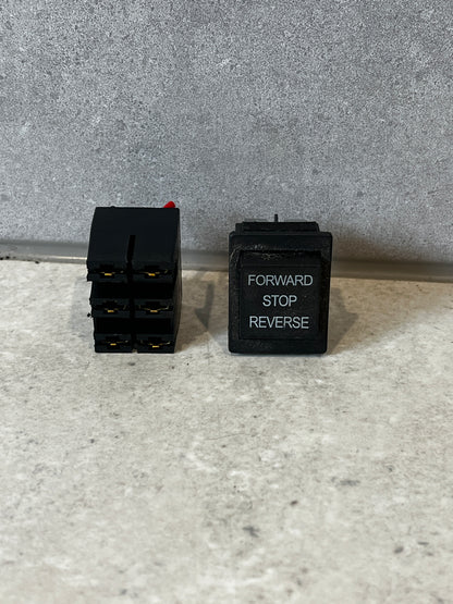 Forward reverse stop rocker switch showing front and side view.