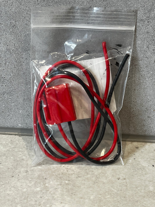 Sealed bag containing red and black insulated wire harness connector