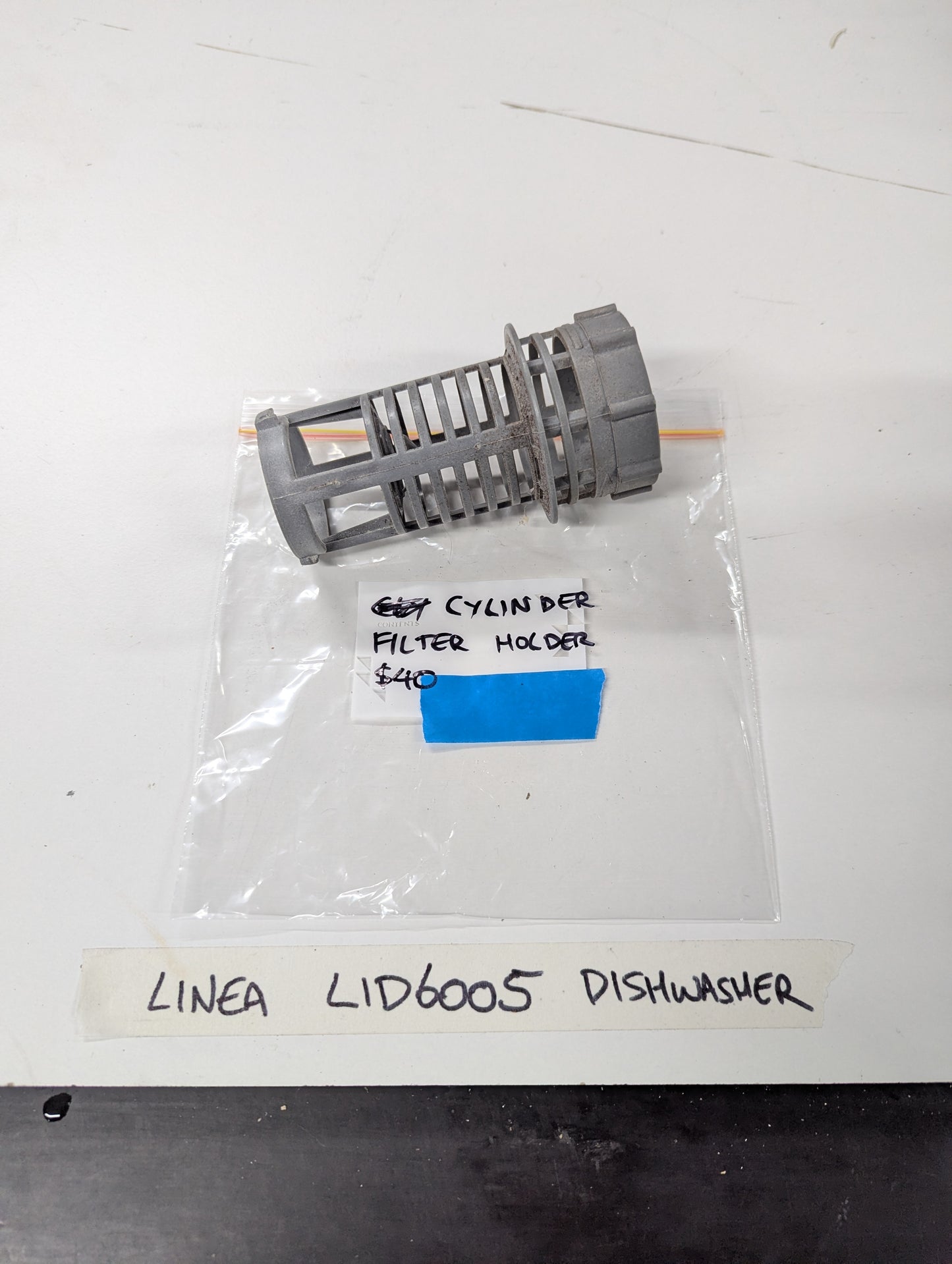 Linea LID6005 dishwasher cylinder filter holder on white surface