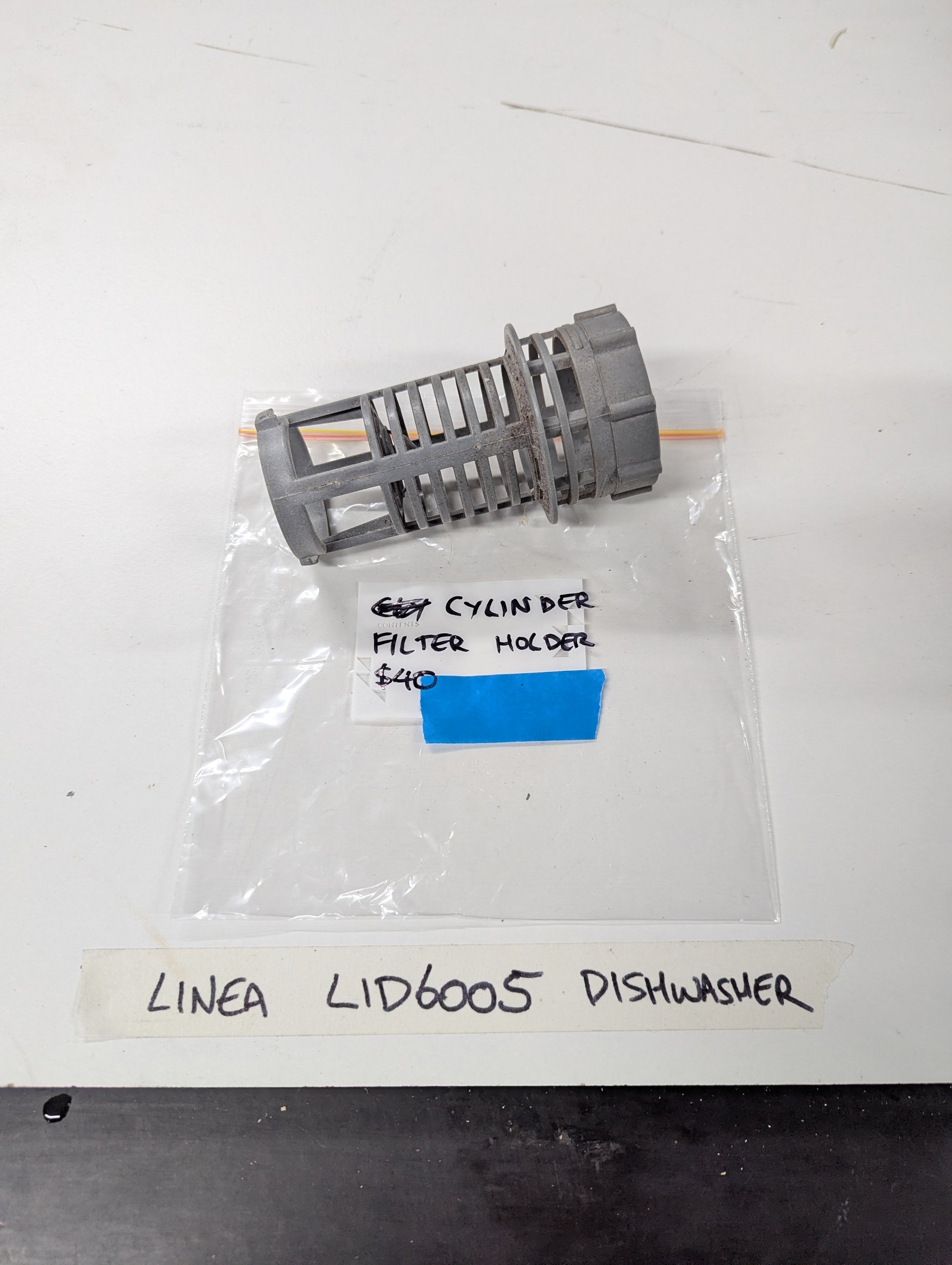 Linea LID6005 dishwasher cylinder filter holder on white surface