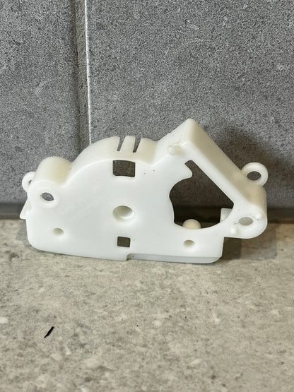 Front view of white plastic mechanical lever bracket on stone background