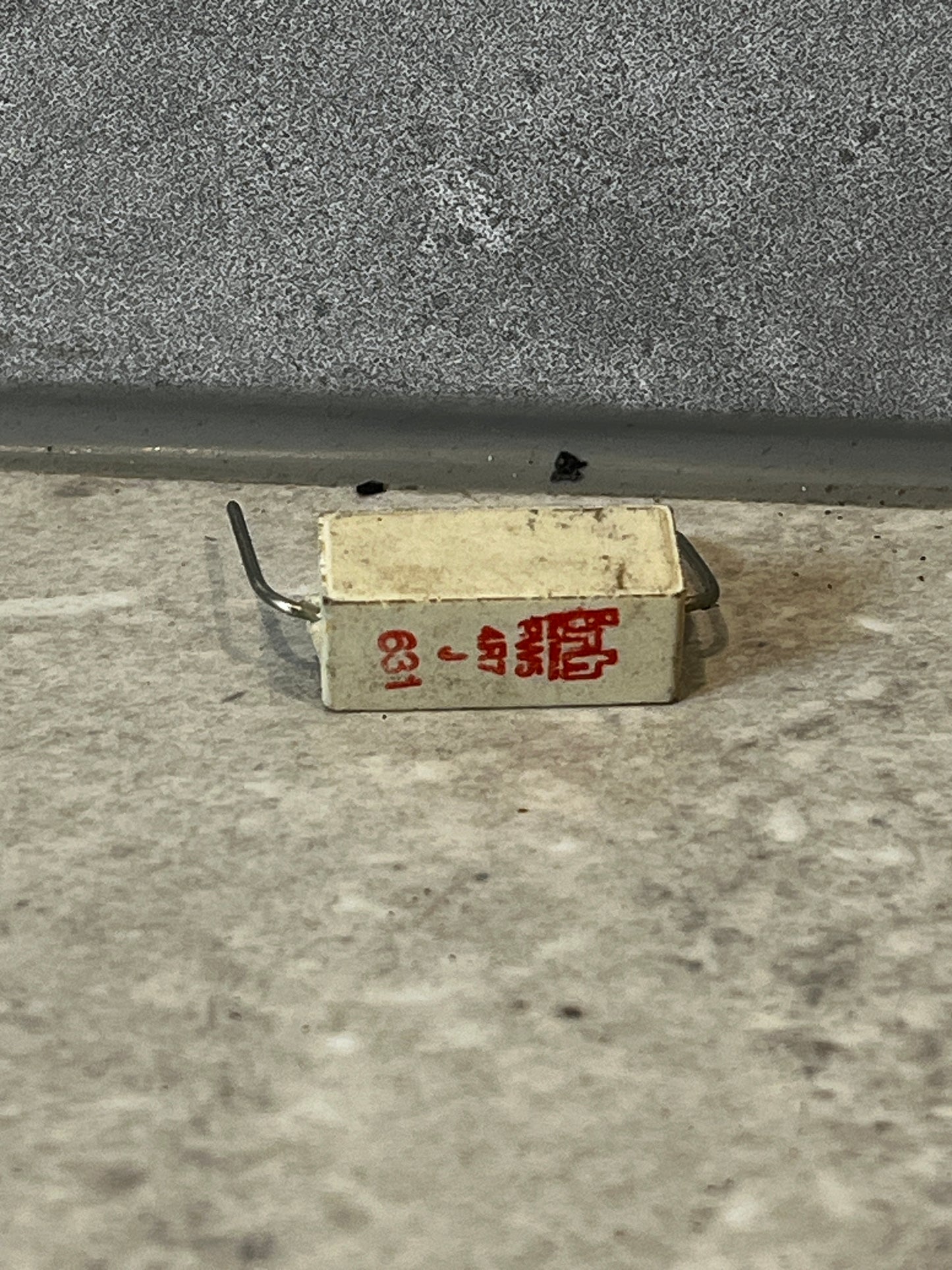 Rectangular wirewound ceramic power resistor with red printed specifications and wire leads