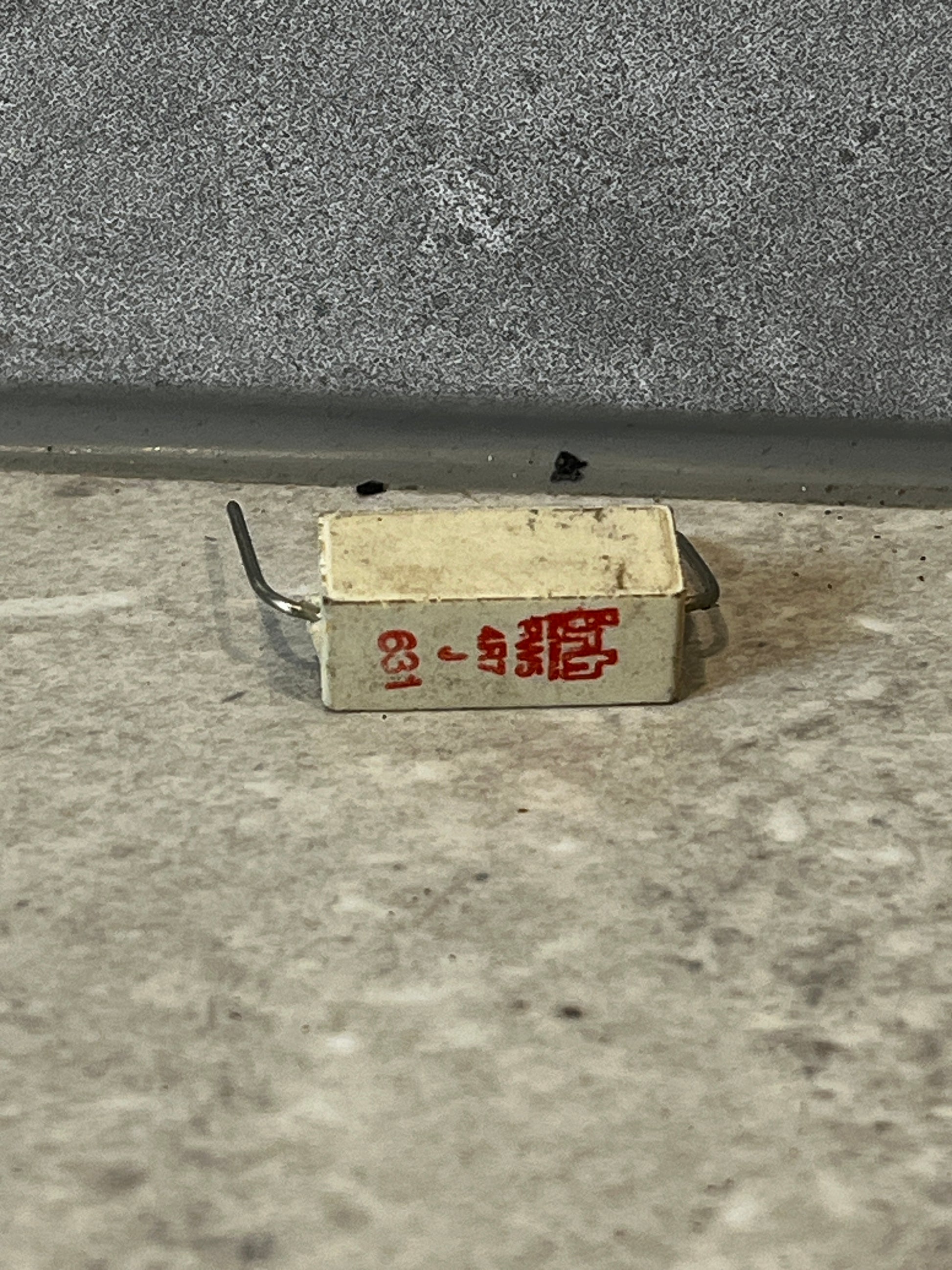 Rectangular wirewound ceramic power resistor with red printed specifications and wire leads
