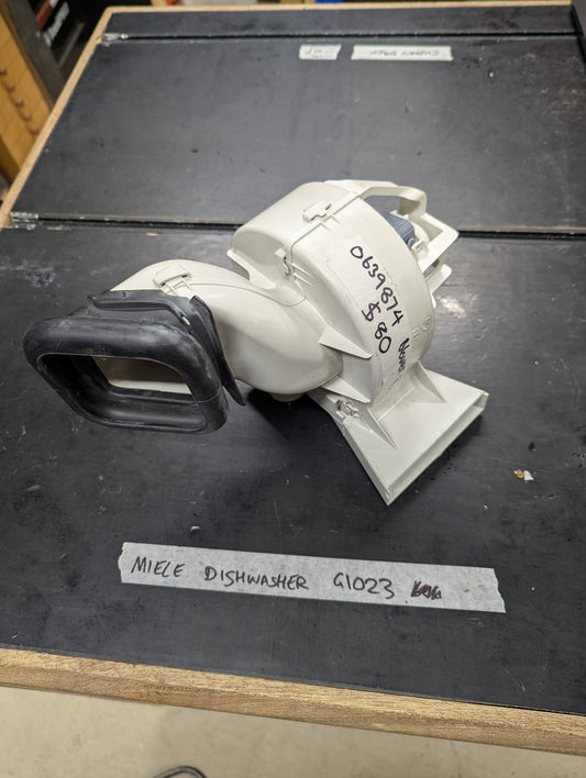 Close-up of Miele G1023 dishwasher blower assembly replacement part on a clean surface