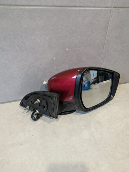 Red right side car mirror assembly showing mounting bolts and mirror glass