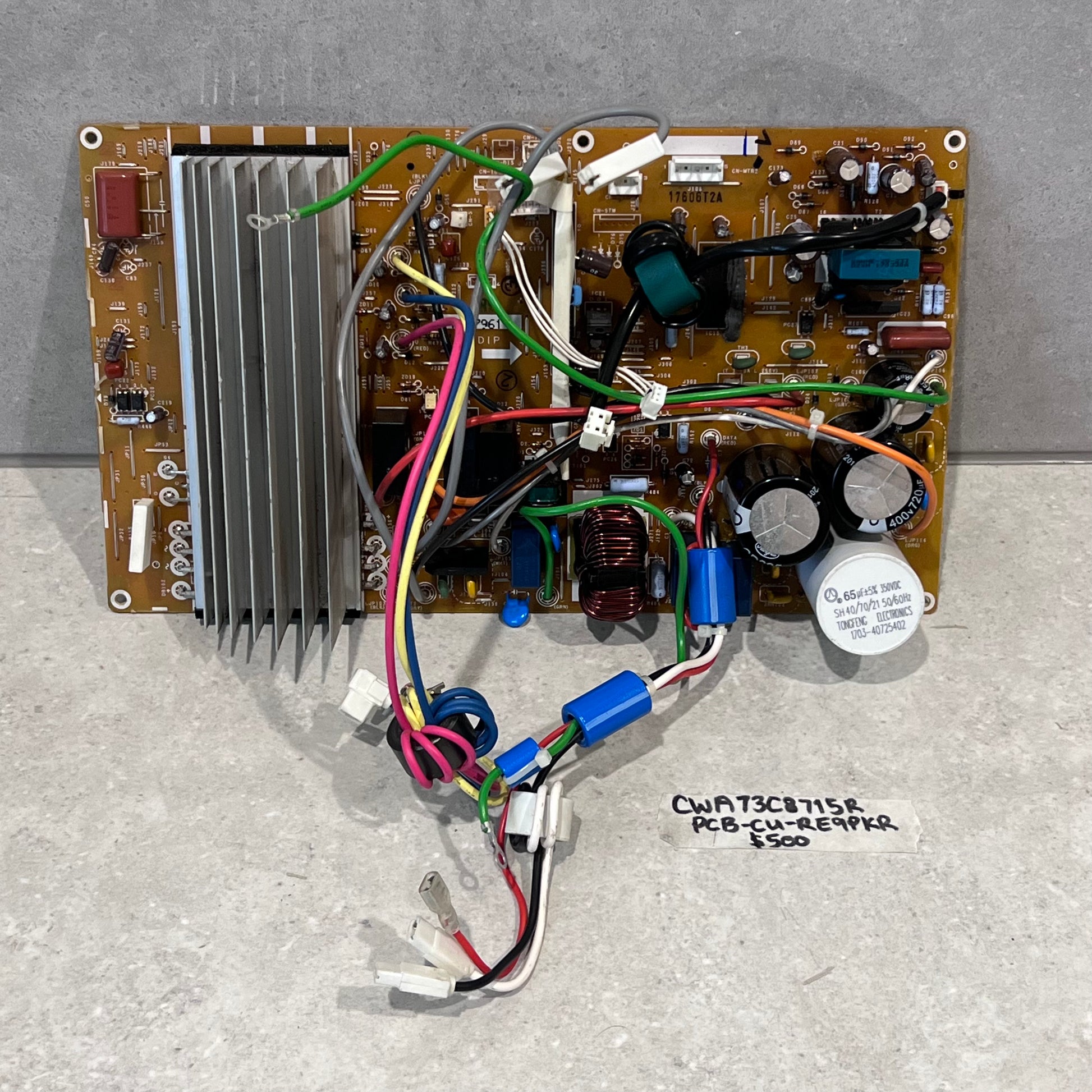 CWA73C8715R PCB control board with wiring harness and heat sink on gray background