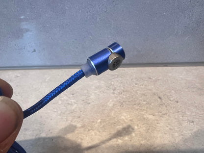 Close-up of blue braided magnetic charging cable with metal connector