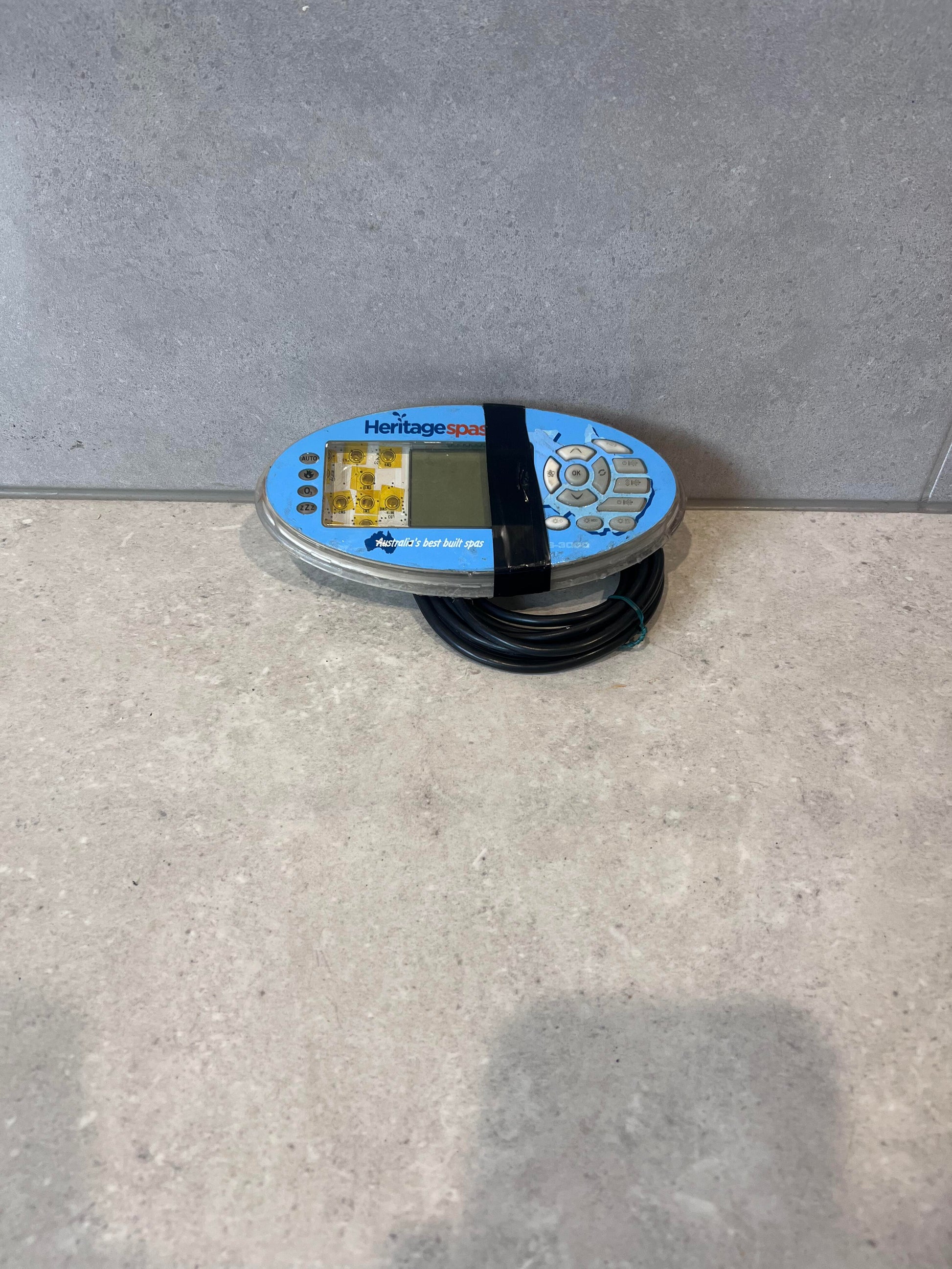 Front view of Heritage Spas digital spa control panel with navigation buttons and display
