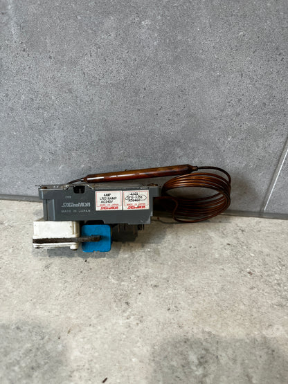 Saginomiya capillary thermostat switch unit with coil on gray surface