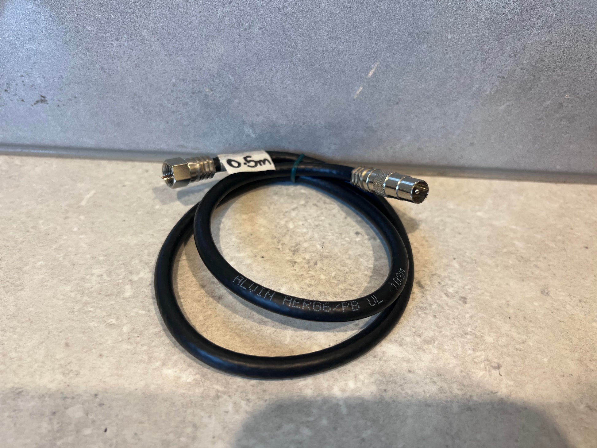 Black coaxial cable with metal F-type connectors on both ends, labeled with 0.5m length