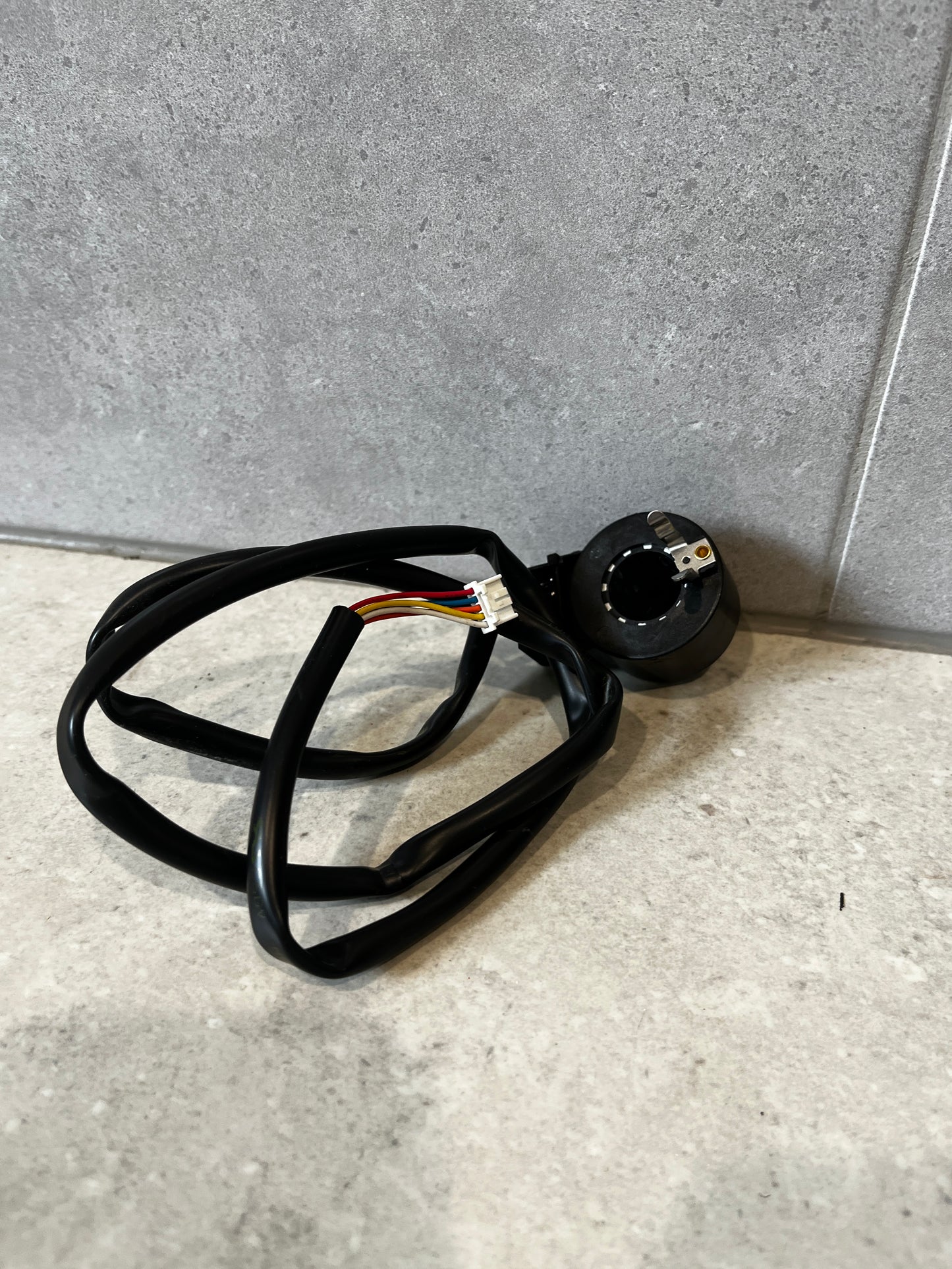 Fujikoki 12V electronic solenoid valve with wiring on gray surface
