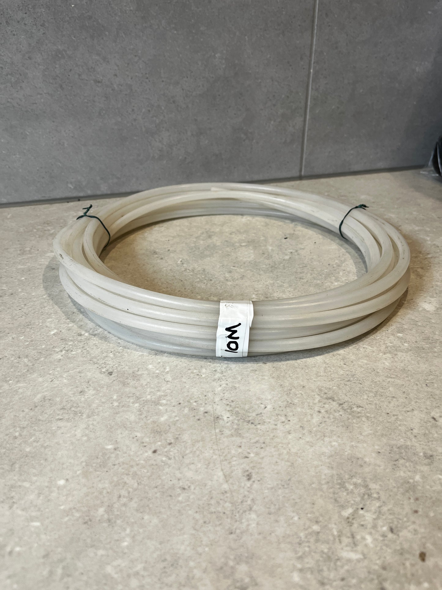 Coiled transparent silicone tubing hose on countertop