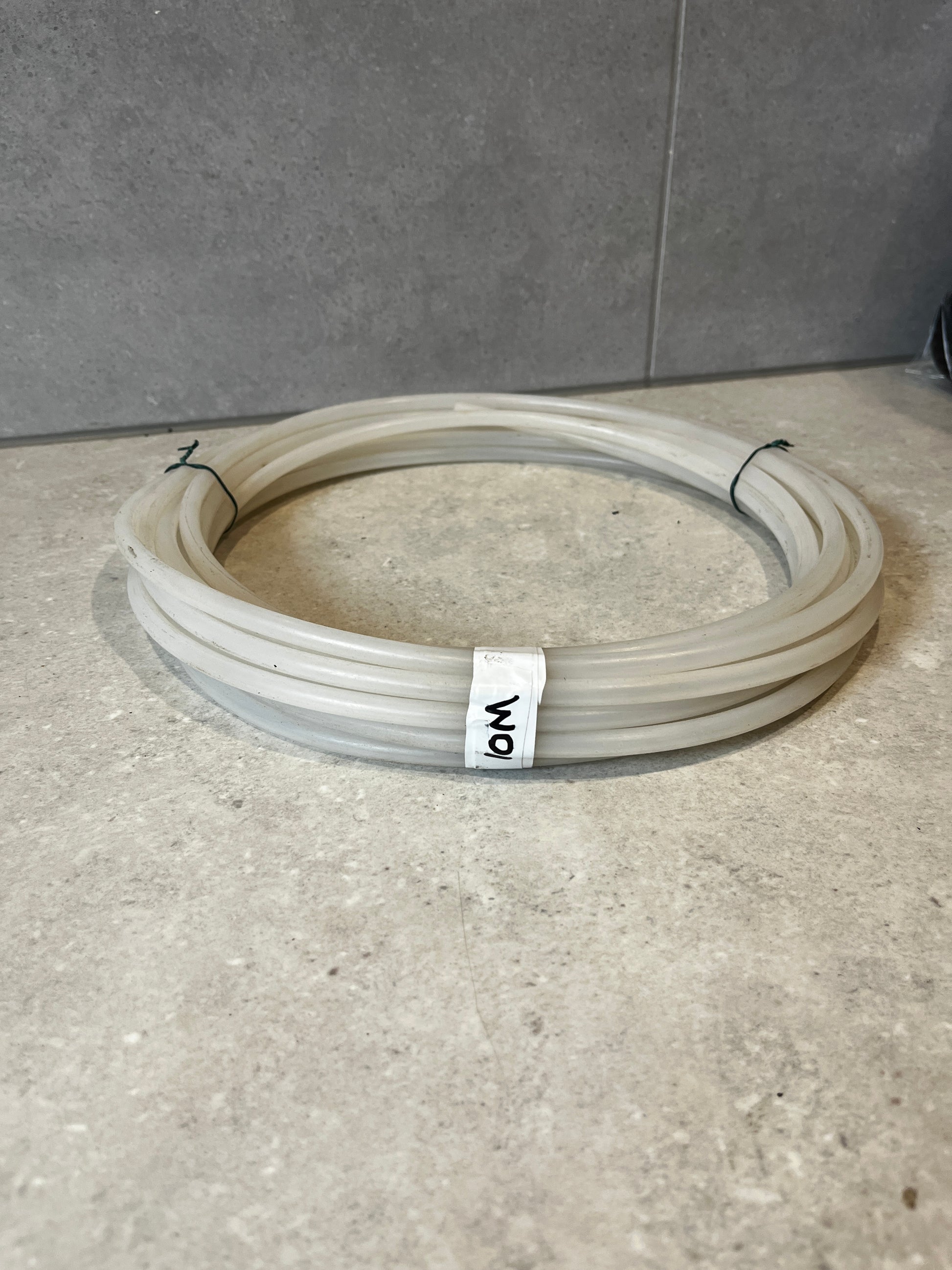 Coiled transparent silicone tubing hose on countertop