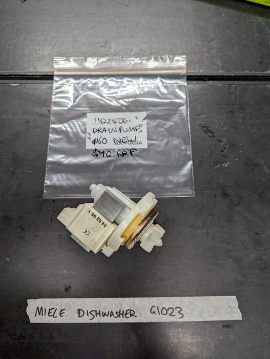 Miele G1023 dishwasher drain pump replacement part on workbench